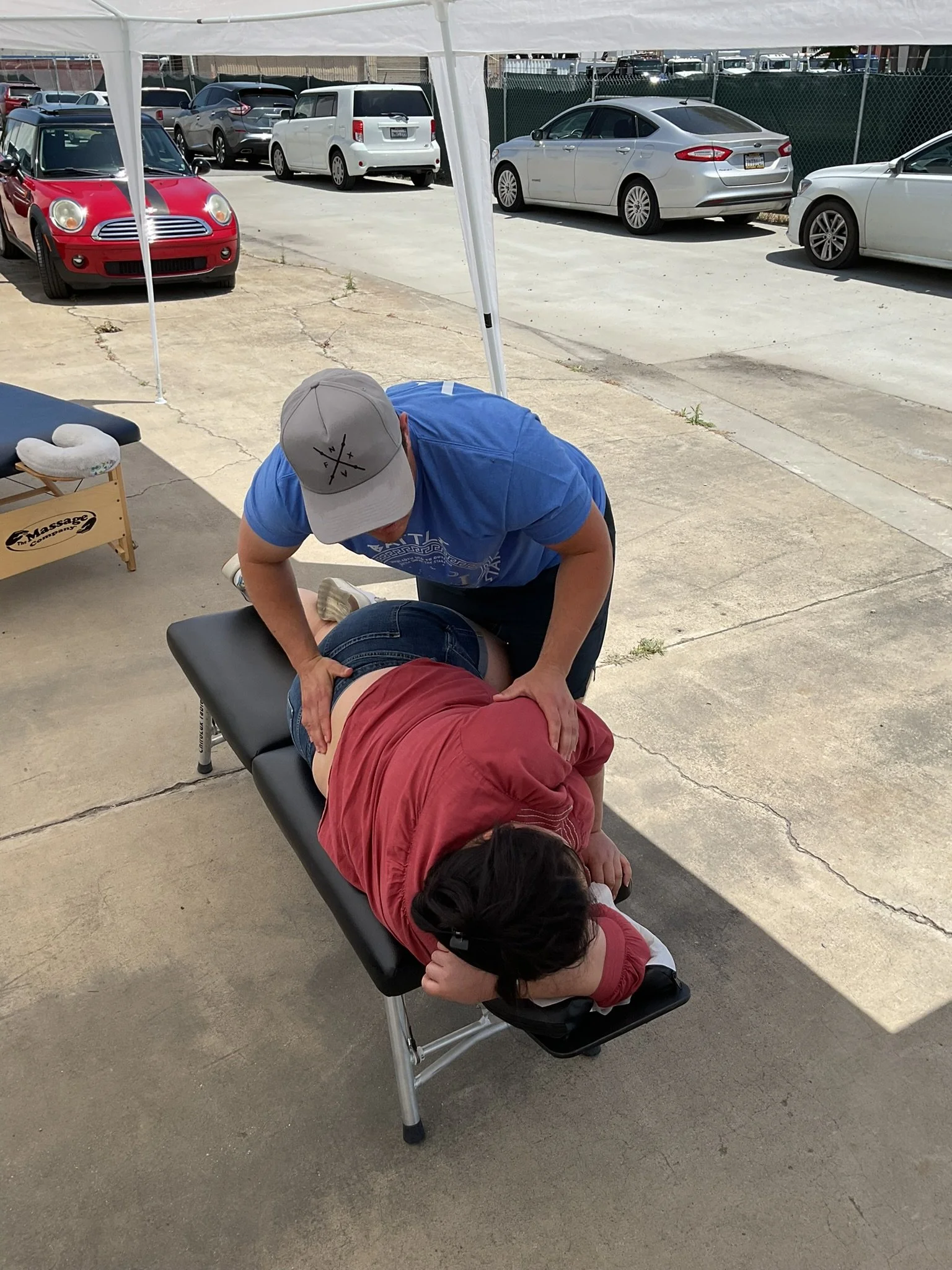 Young woman lying face down on treatment table with therapeutic cups along spine.
