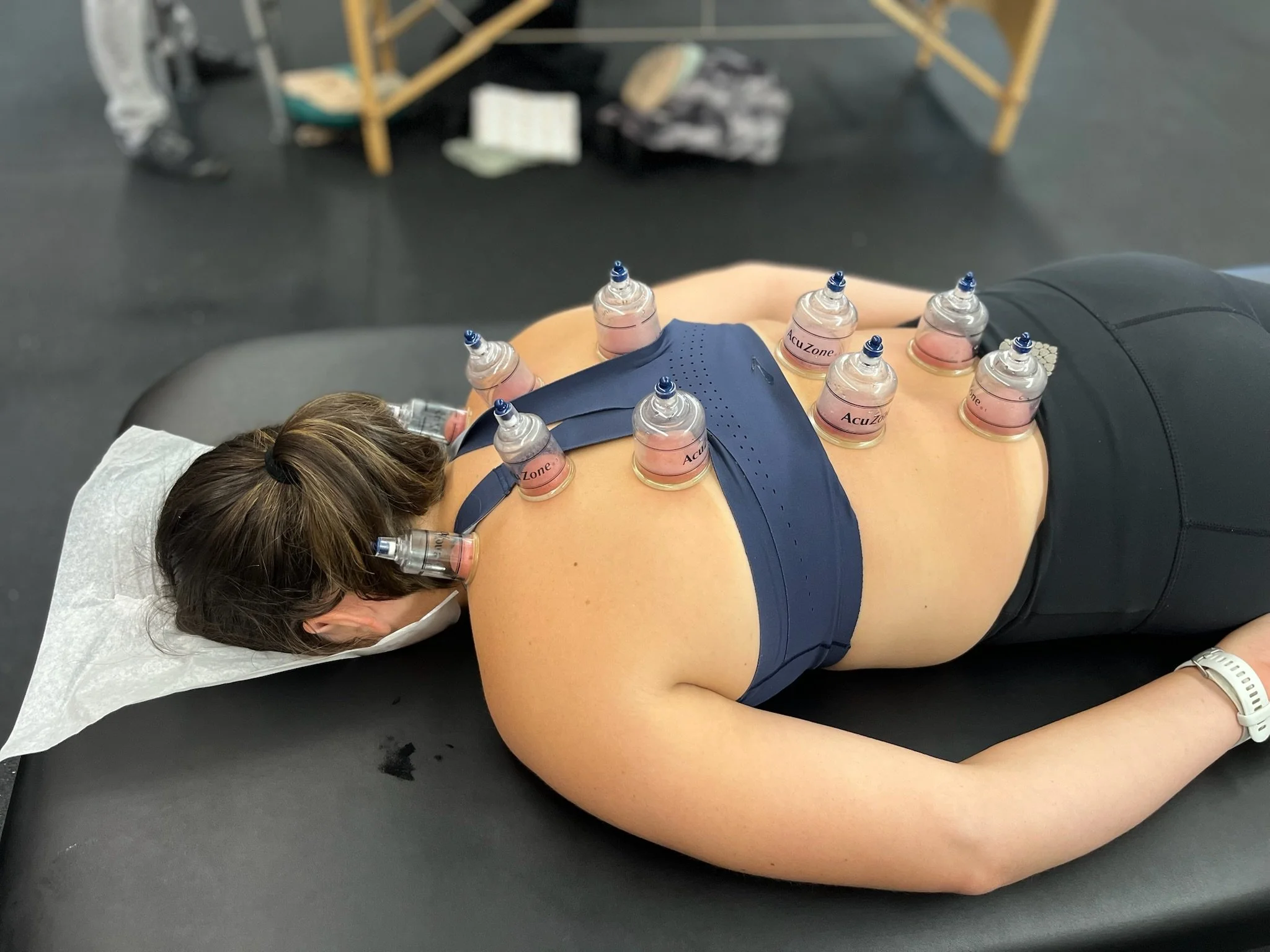 Women holding her right elbow with her left hand, the elbow is highlighted in red to show pain.