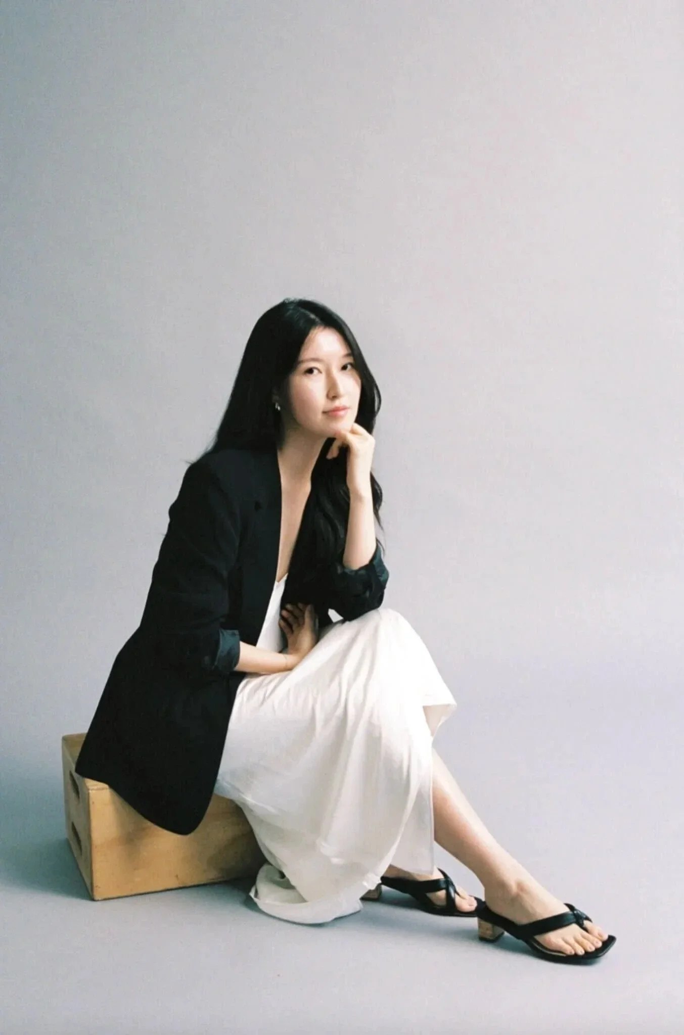 Youjin, a wellness brand designer, sitting on chair