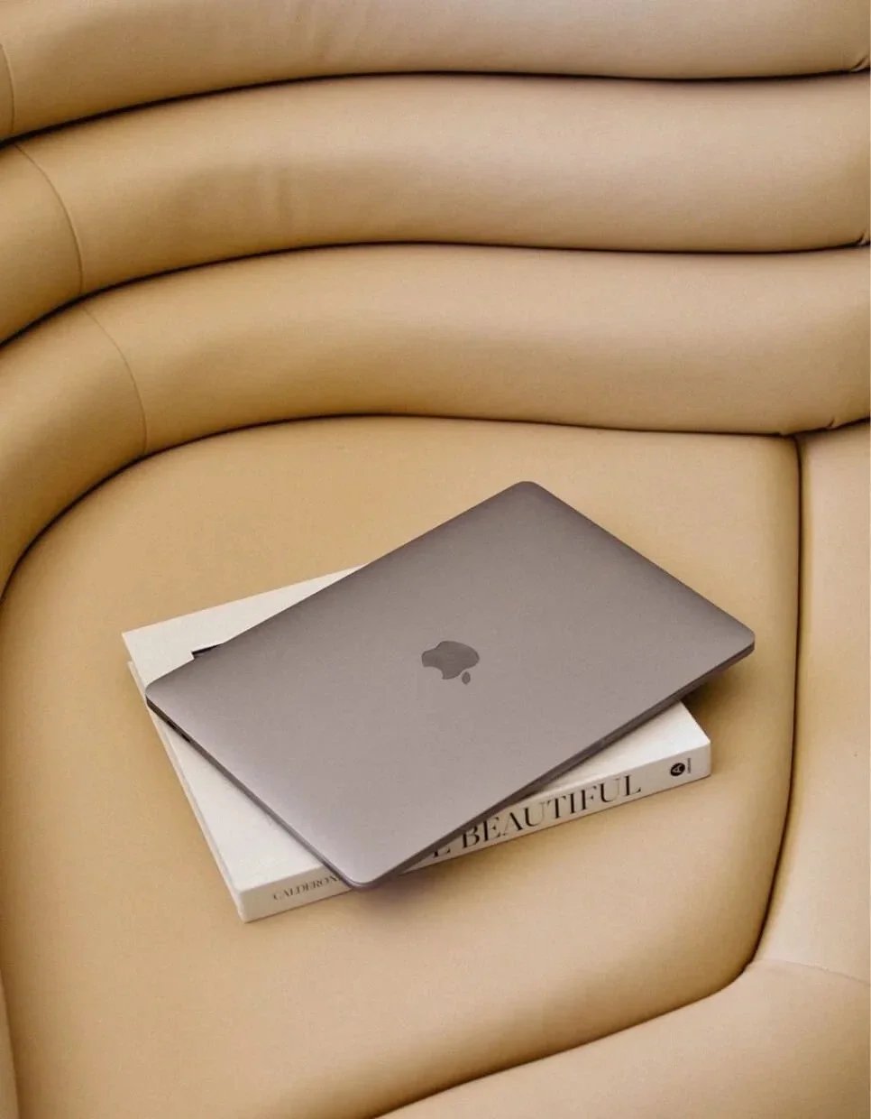 laptop on couch showcasing Adoro Secco offering branding and design services for beauty and wellness companies