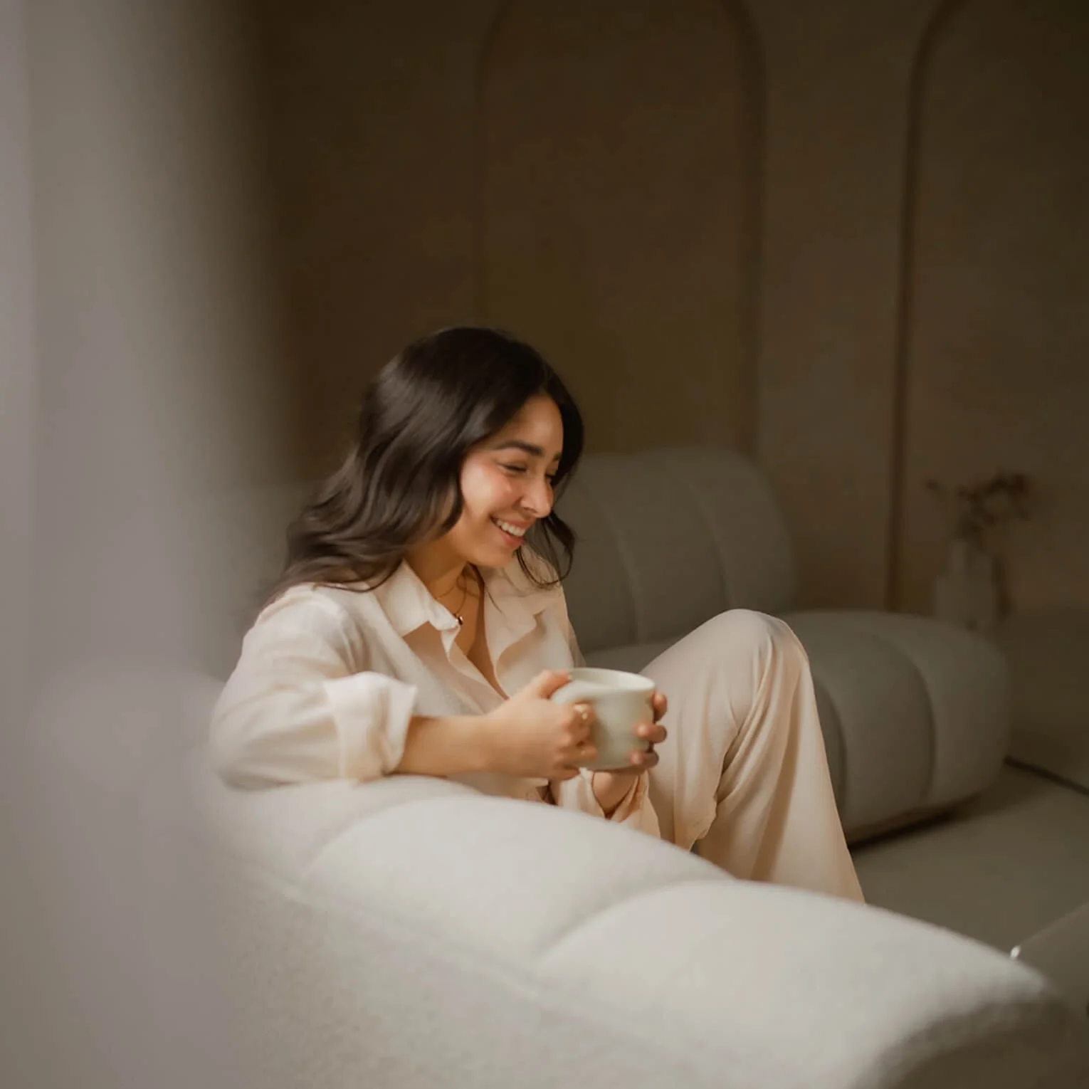 Woman sitting on couch from website design companies in Los Angeles, CA