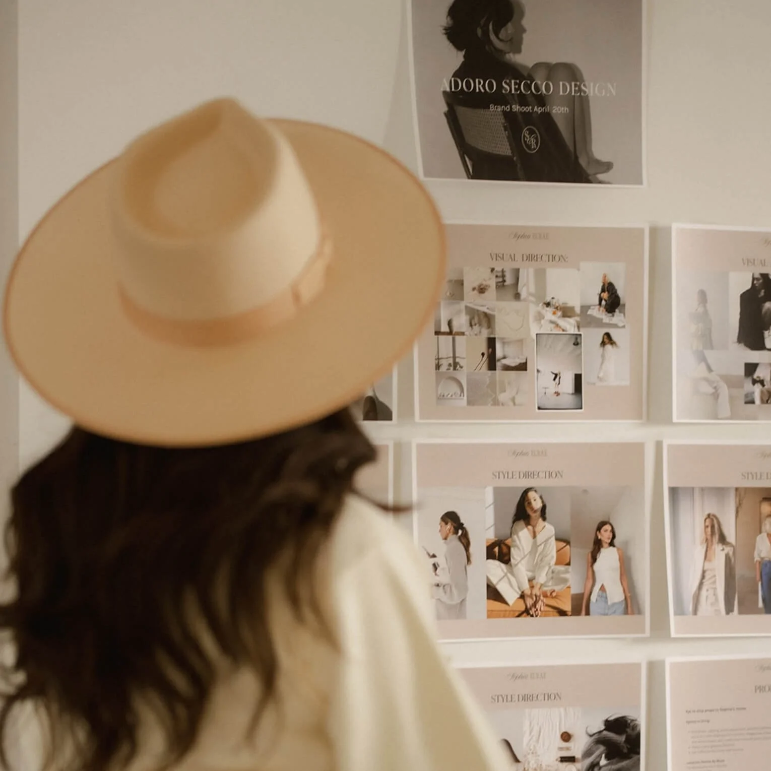 Web designer in Los Angeles looking at mood board up on the wall