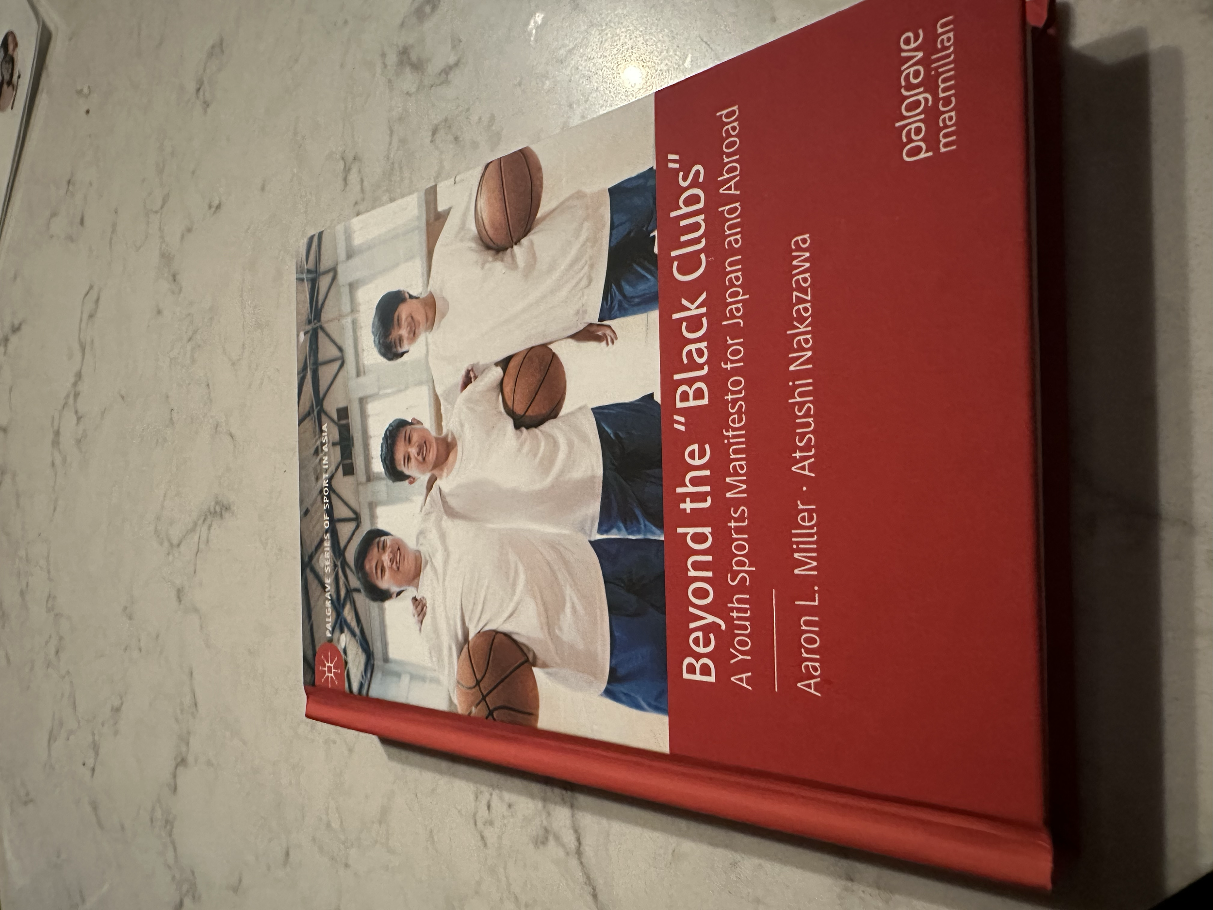 Book cover titled "Beyond the Black Clubs" with a photo of three young men holding basketballs, standing in a gymnasium.