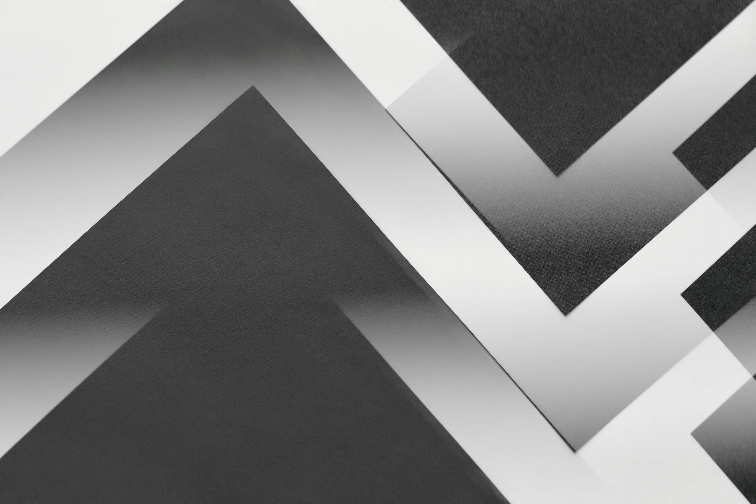 abstract image of greyscale lines intersecting forming letter vs and chevrons with gradients