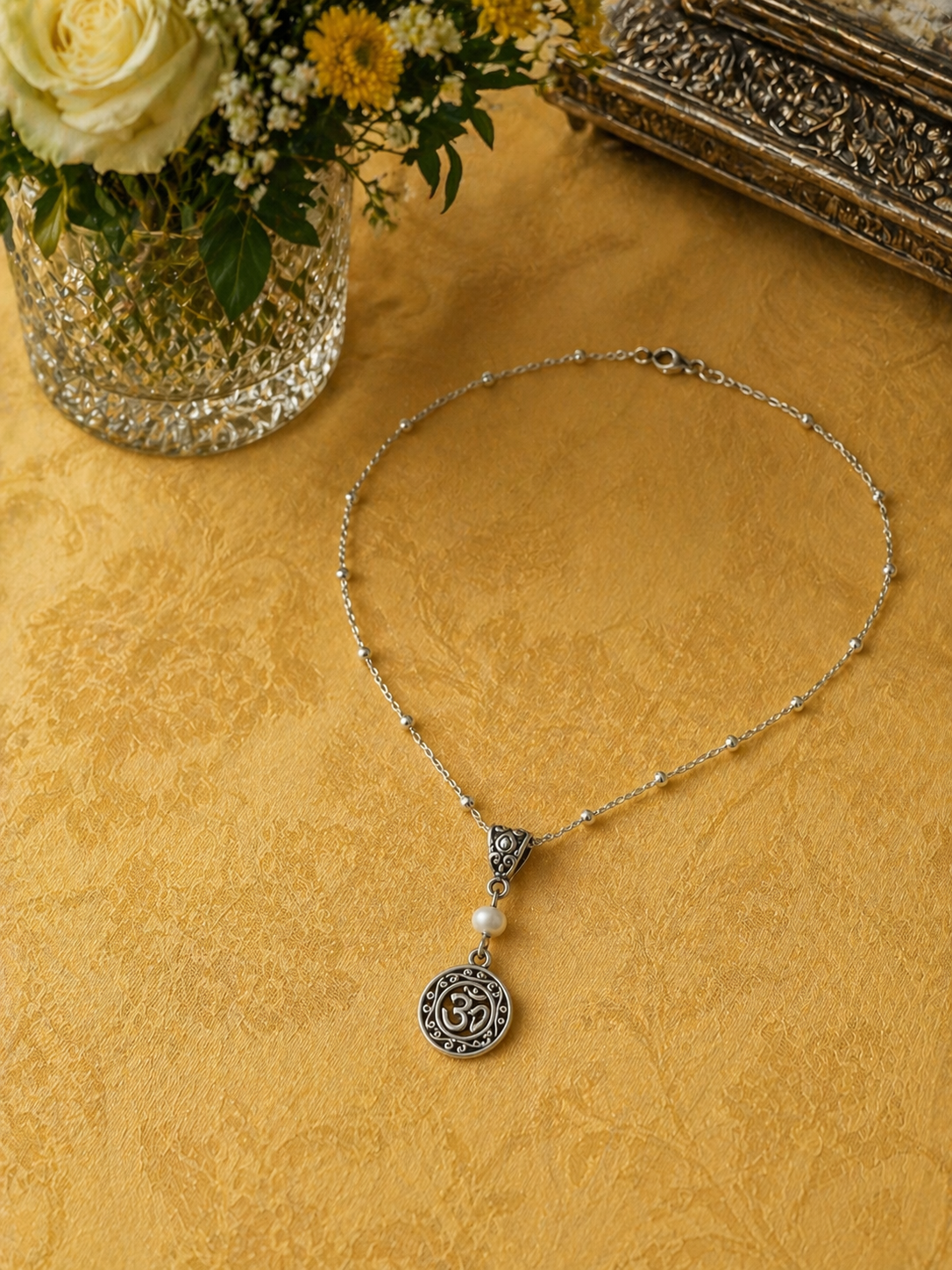 Om Pearl Necklace Yellow Tablecloth ChatGPT.png