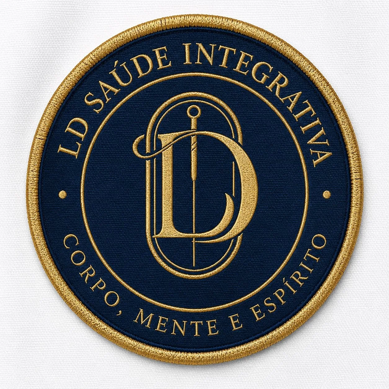 Embroidered patch of the LGBT Saúde Integradiva logo with a navy blue background, gold border, and gold text reading 'LGBT Saúde Integrativa, Corpo, Mente e Espírito' with an intertwined 'D' and compass design in the center.