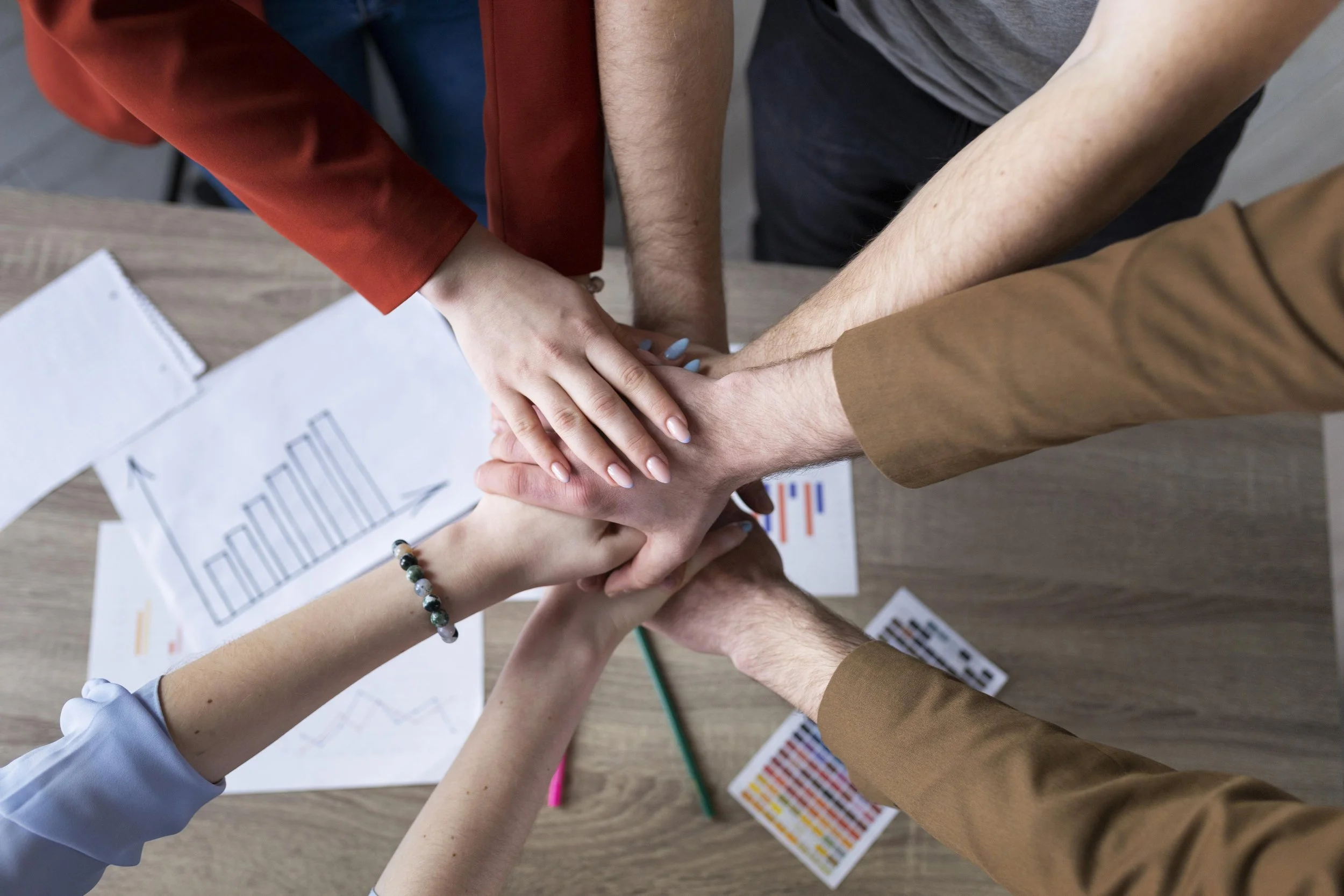 group-coworkers-putting-their-hands-together.jpg