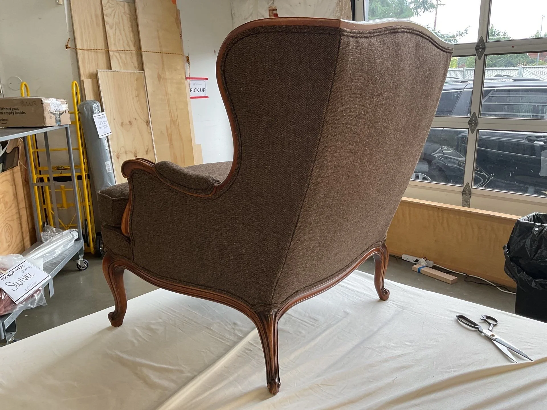Finished custom reupholstered chair with hand-sewn welting and pattern-matched fabric