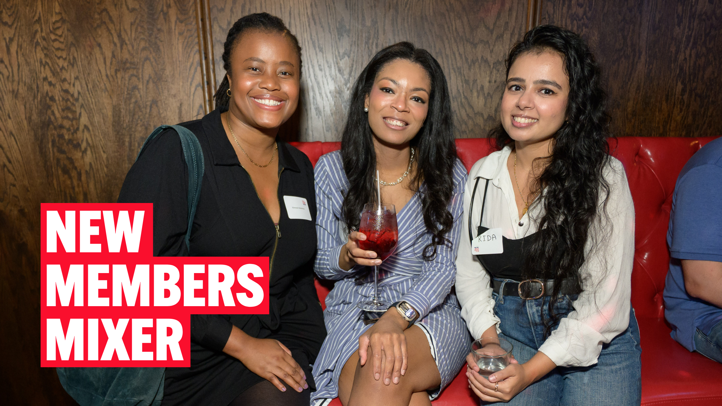 Three new SGSNY members, sat with cocktails and smiling at the camera.