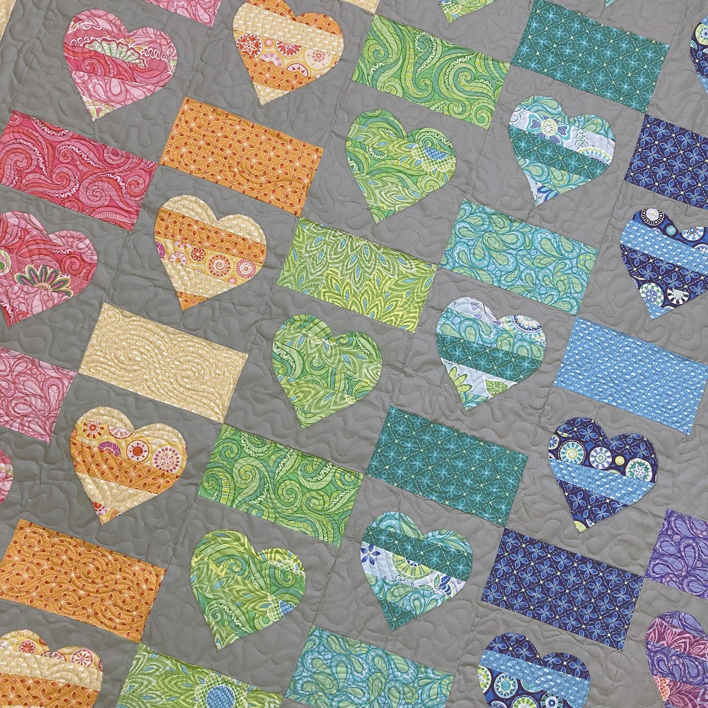 closeup of rainbow heart quilt