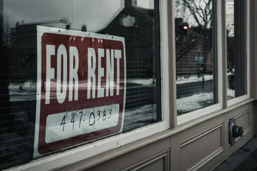 A For Rent sign displayed in the window of an investment property.