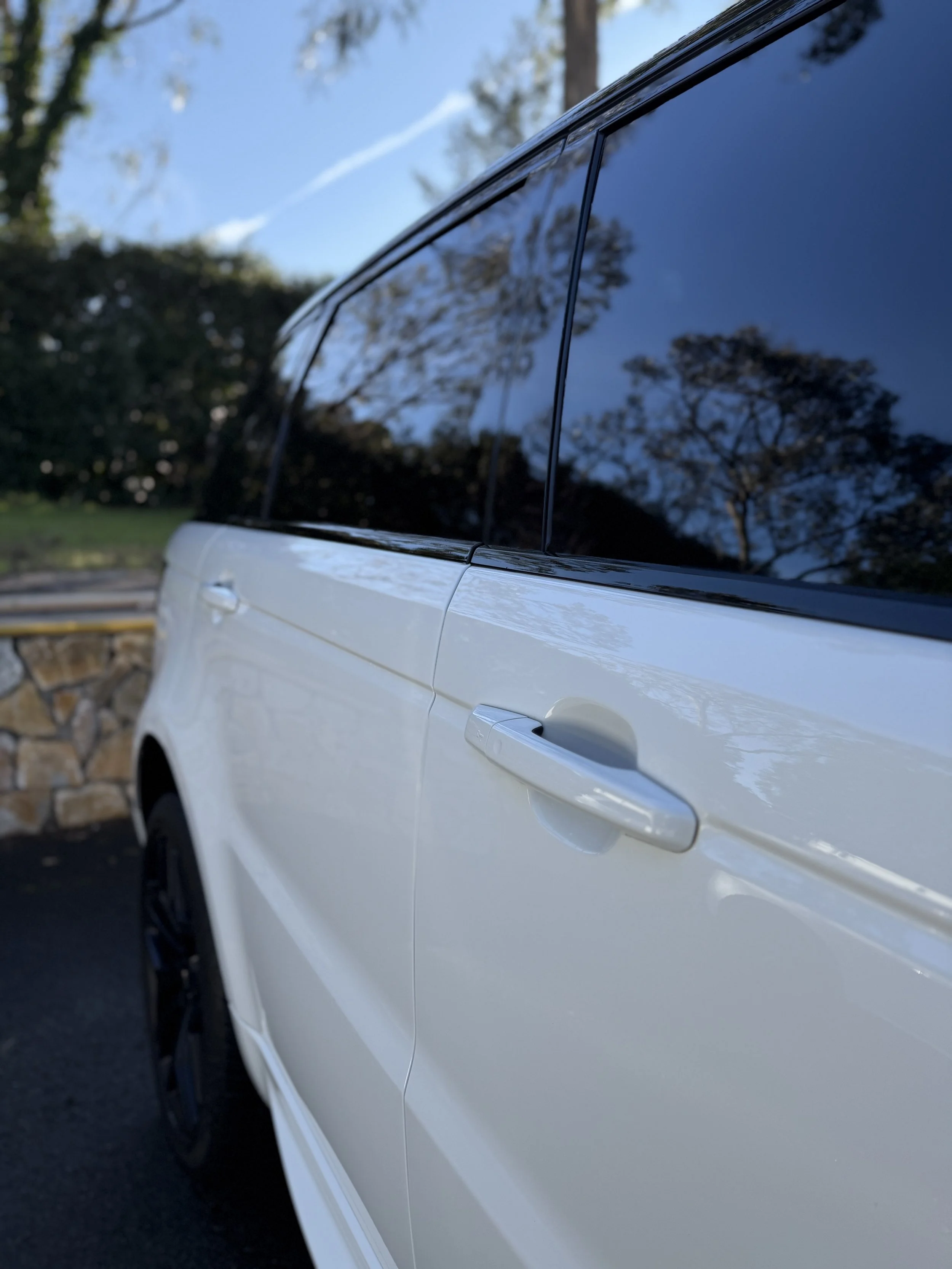 a close up of a white Range Rover Sport after a one-step paint correction