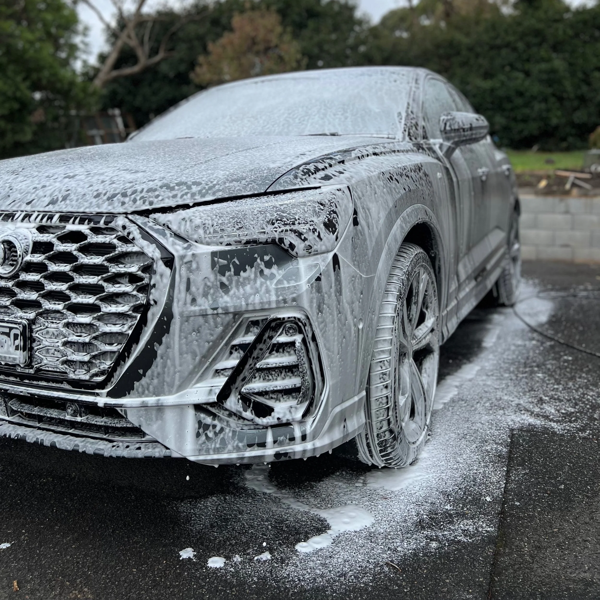 Audi Q3 covered in pre-wash foam soap during an exterior detail