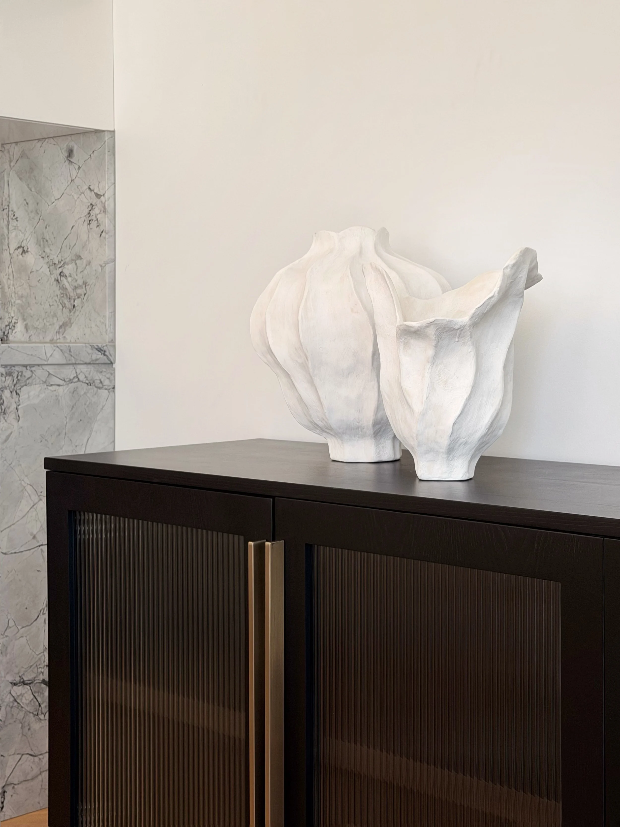 The details are what transform a house into a home buyers remember.

Fluted glass, warm bronze hardware, sculptural forms &amp; natural stone come together to create a moment that feels both timeless &amp; considered. 

styled by. @mca_interiors