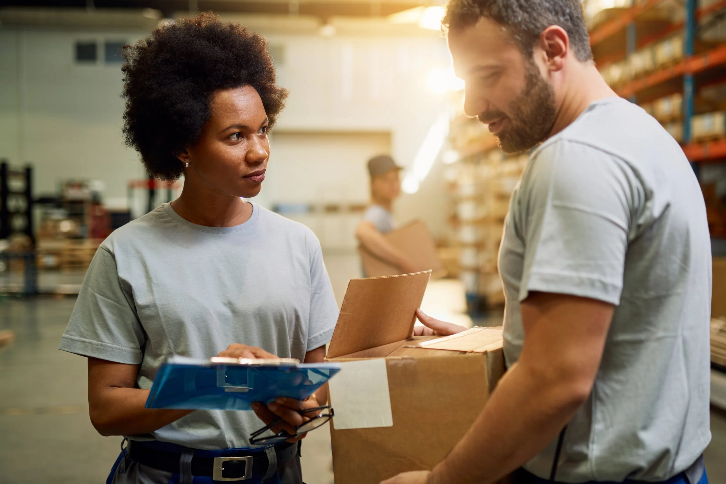 A sales rep in a warehouse with a customer providing insightful product recommendations