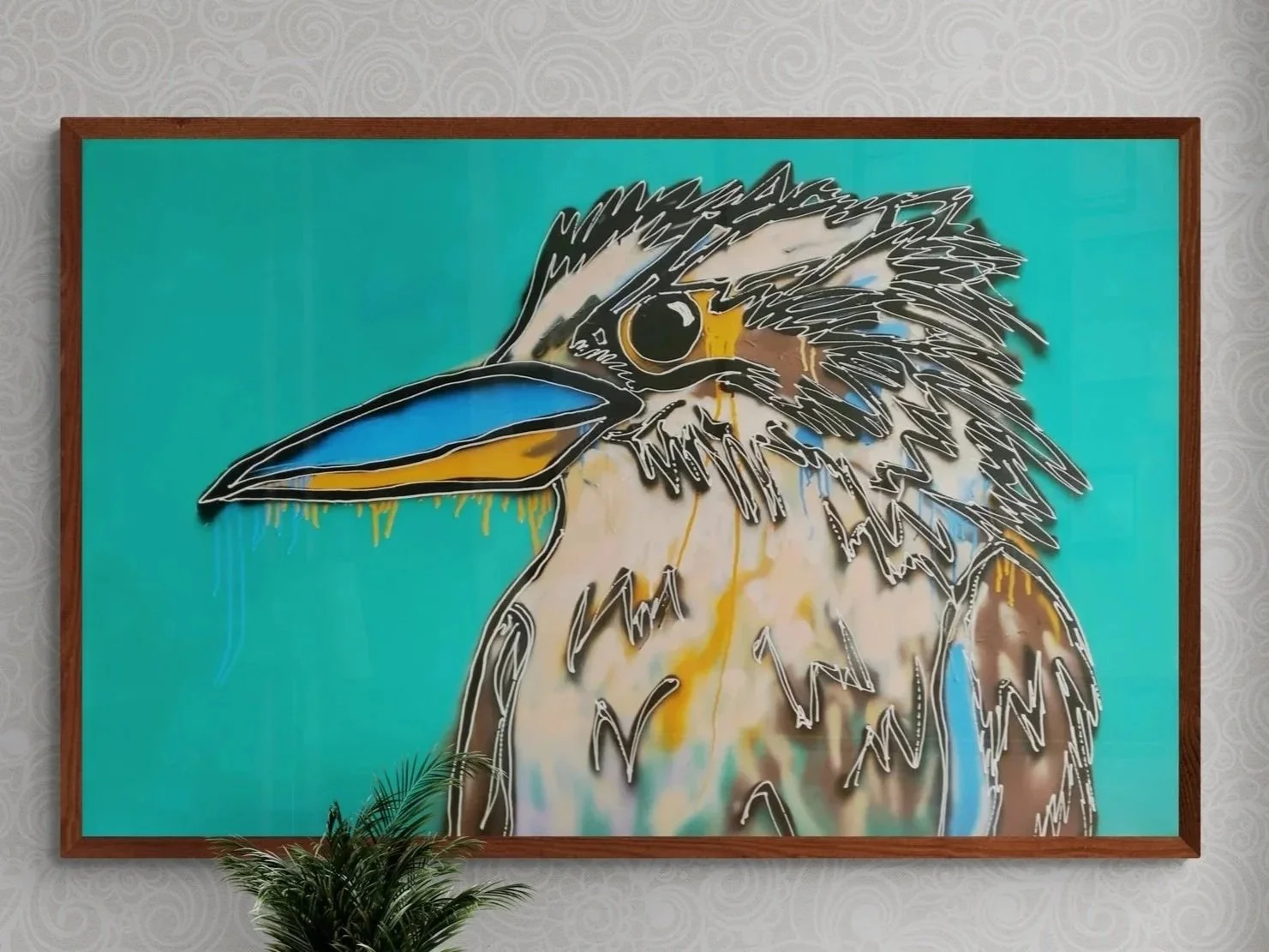 Colorful painting of a kookaburra bird with a blue and yellow beak, set against a teal background, framed in wood. Artwork by Daniel Kotynia. Tasmanian Artist.