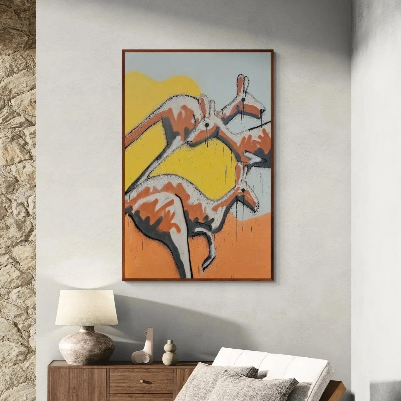 Abstract painting of four alkaline docked goats on a multicolored background hanging on a white wall in a modern living room.