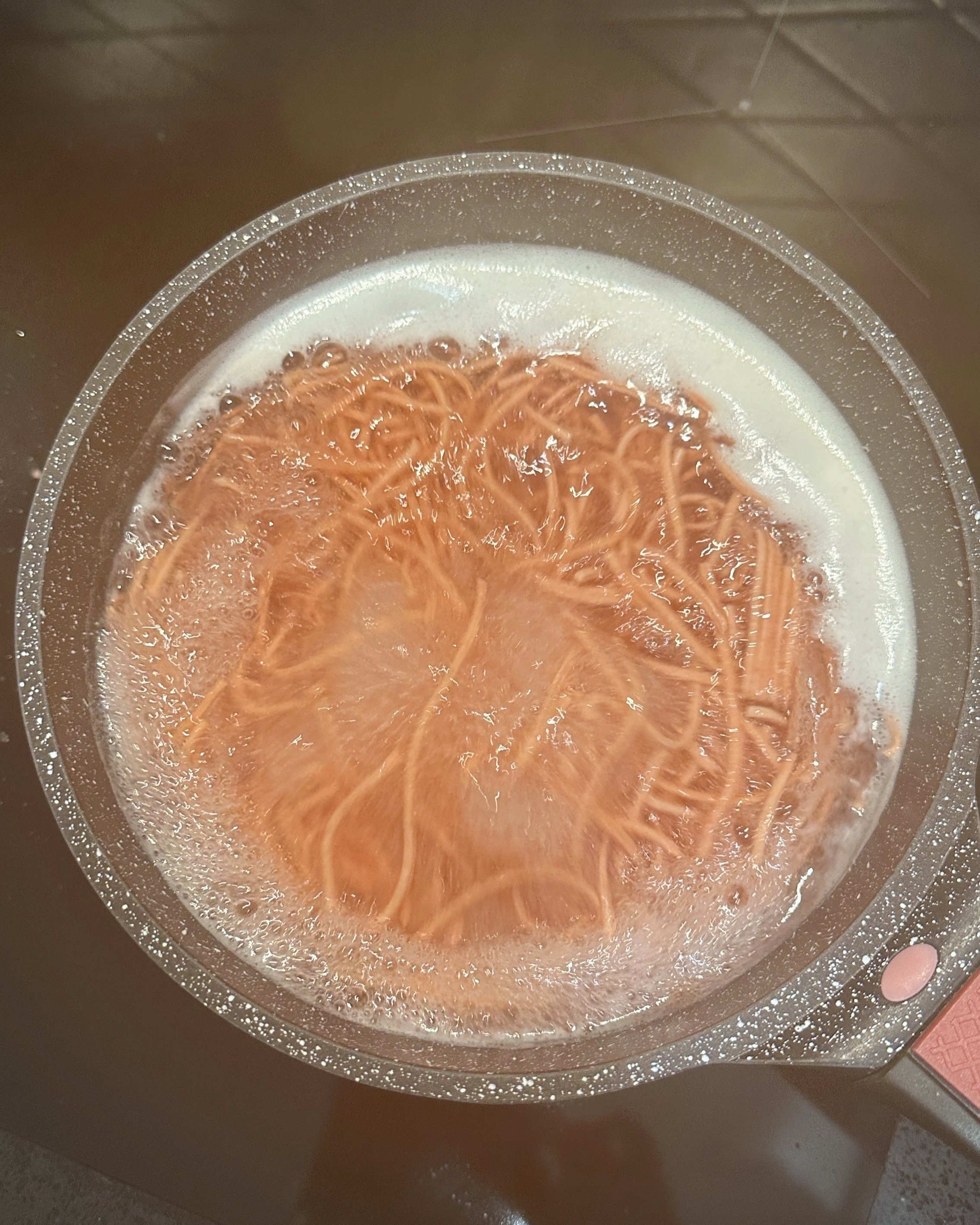 Spaghetti pasta boiling in a pot of water.