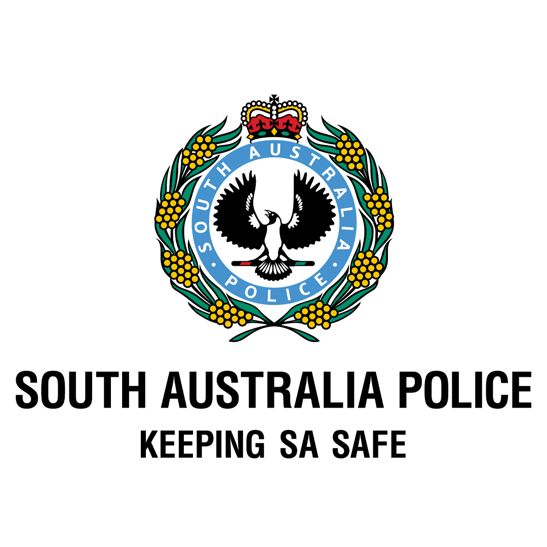 South Australia Police badge with a crown, boomerangs, and a black cockatoo, accompanied by the text "South Australia Police" and the slogan "Keeping SA Safe" against a black and gray background.