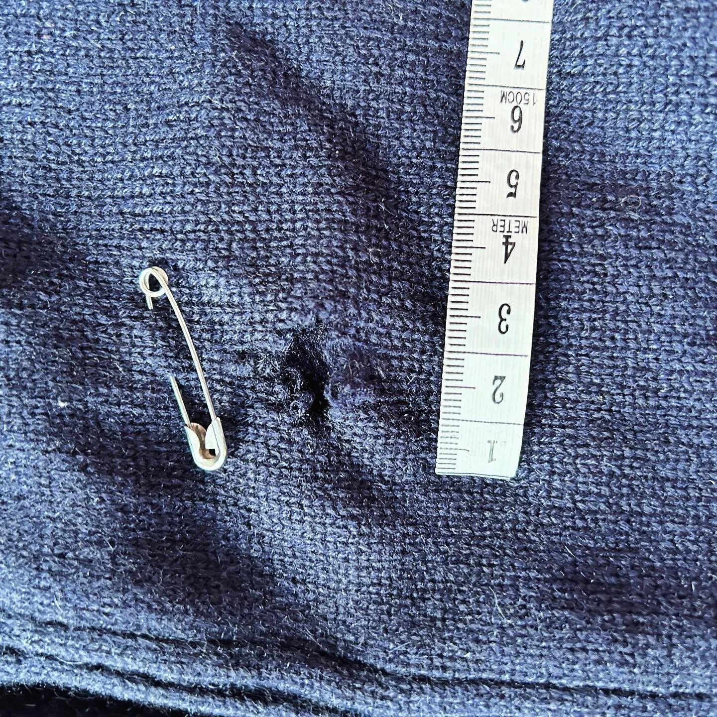 This is warm and cozy Hunter cashmere cardigan was a tacked by silverfish. There is a large hole in the elbow and the threads around it were all thin and weak. 
Our mending re-wove new threads into the area to reenforce the fabric. 
The result is onl