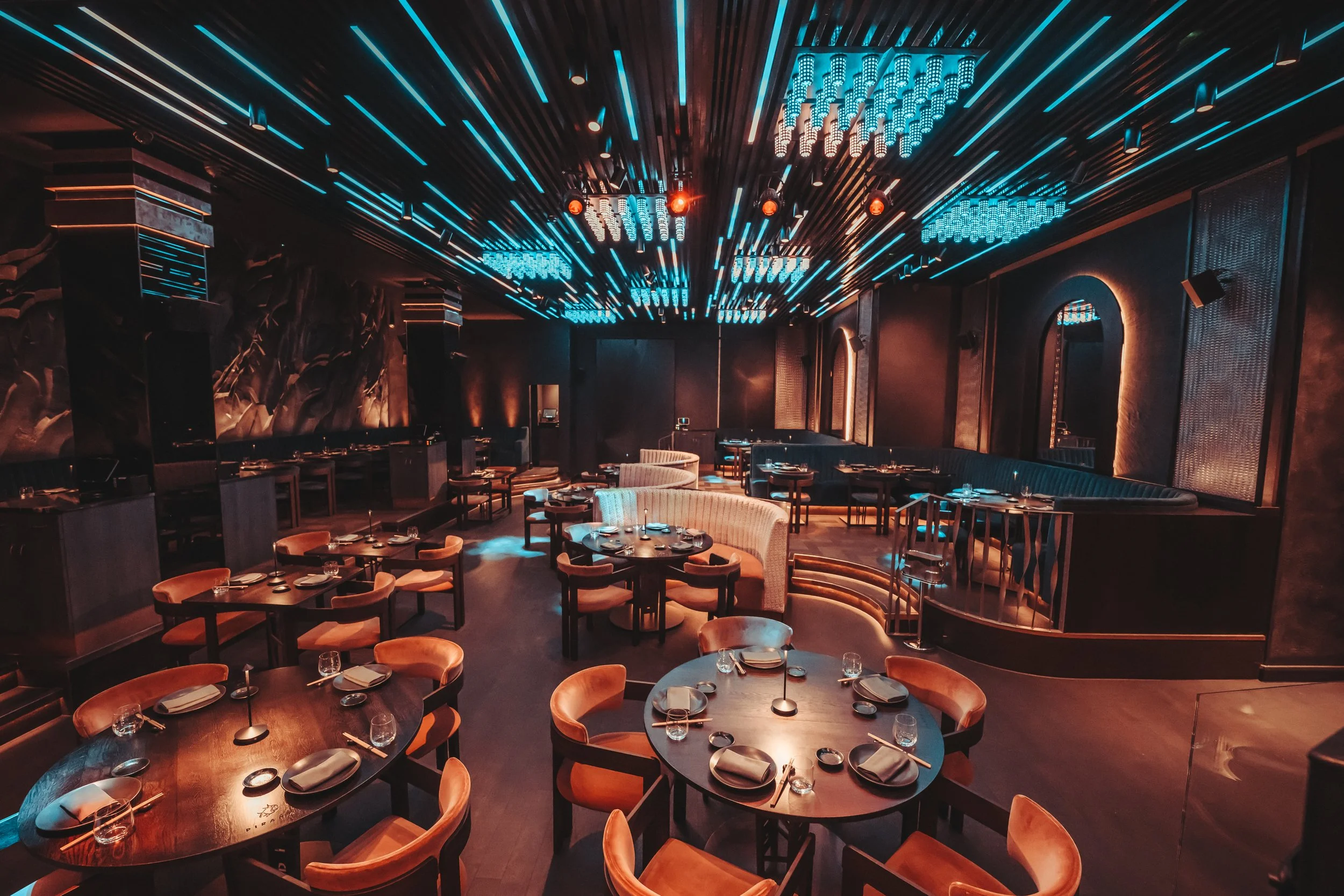 Piraña restaurant interior with amber accent lighting.