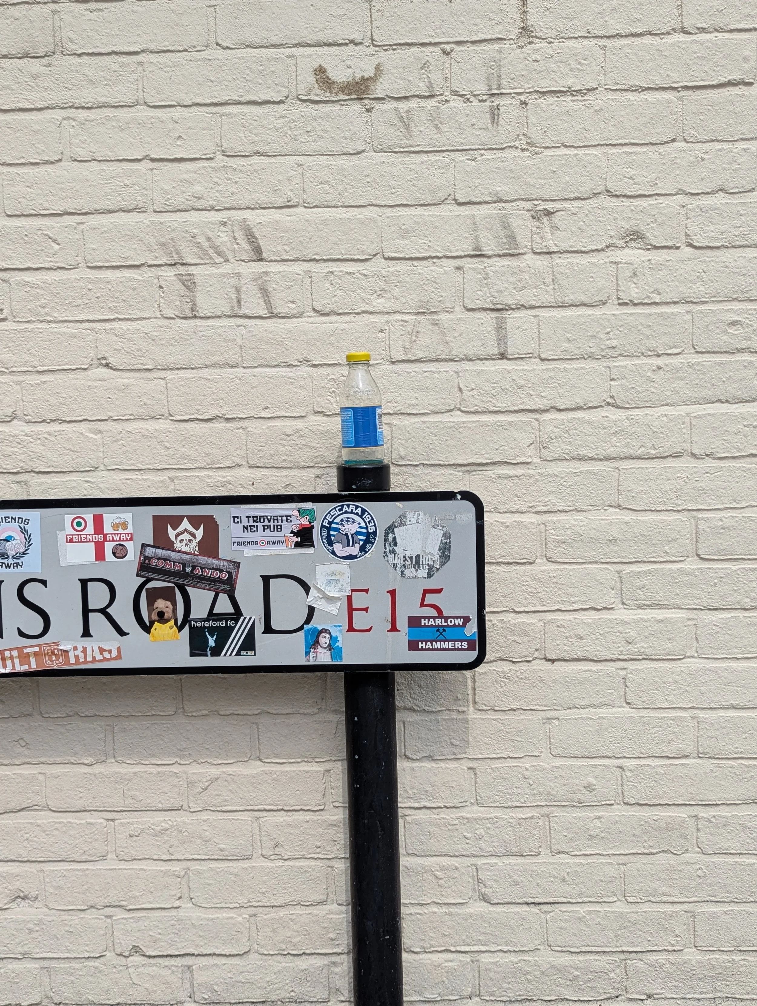 Carpenters Road street sign with stickers.jpg