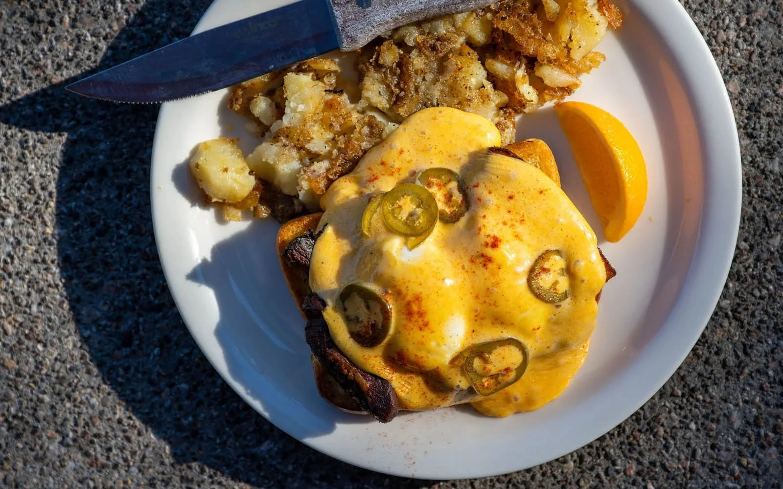  Pork Belly Benedict: Seared Pork Belly, Poached Eggs, Cajun Hollandaise, Pickled Jalapeños, Griddled Texas Toast, Garlic Home Fries 