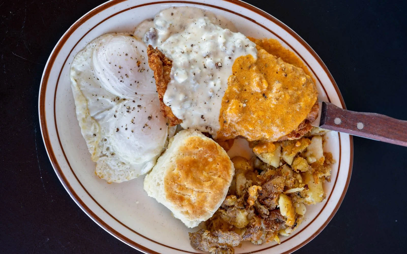  Country Fried Chicken, Sausage Gravy, Chorizo Gravy, Poached Eggs, Garlic Home Fries, Buttermilk Biscuits 