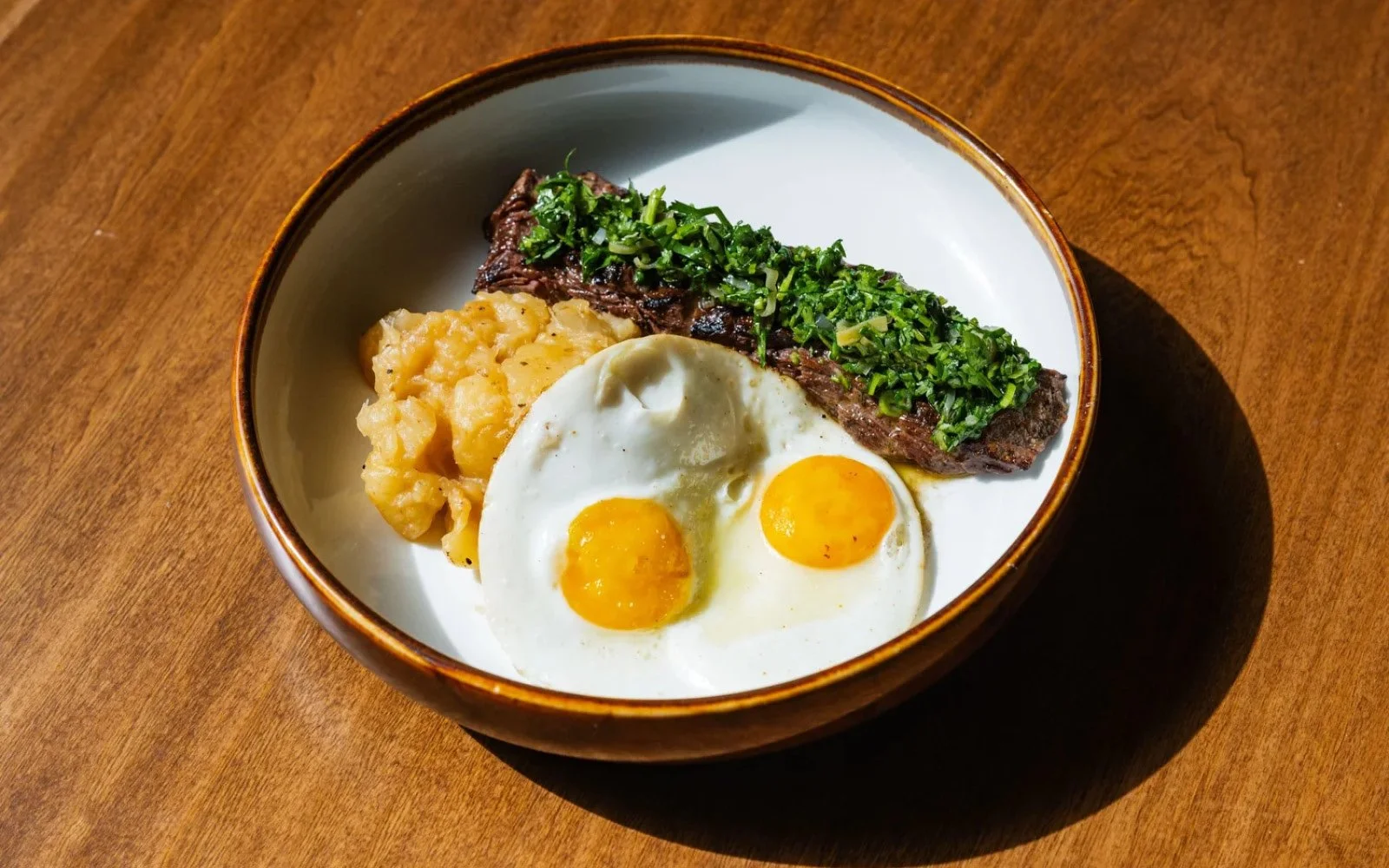  Steak Churrasco, Sunny Side Up Eggs, Yuca Encebollada, Fermented Leek-Mushroom Oil Chimichurri 