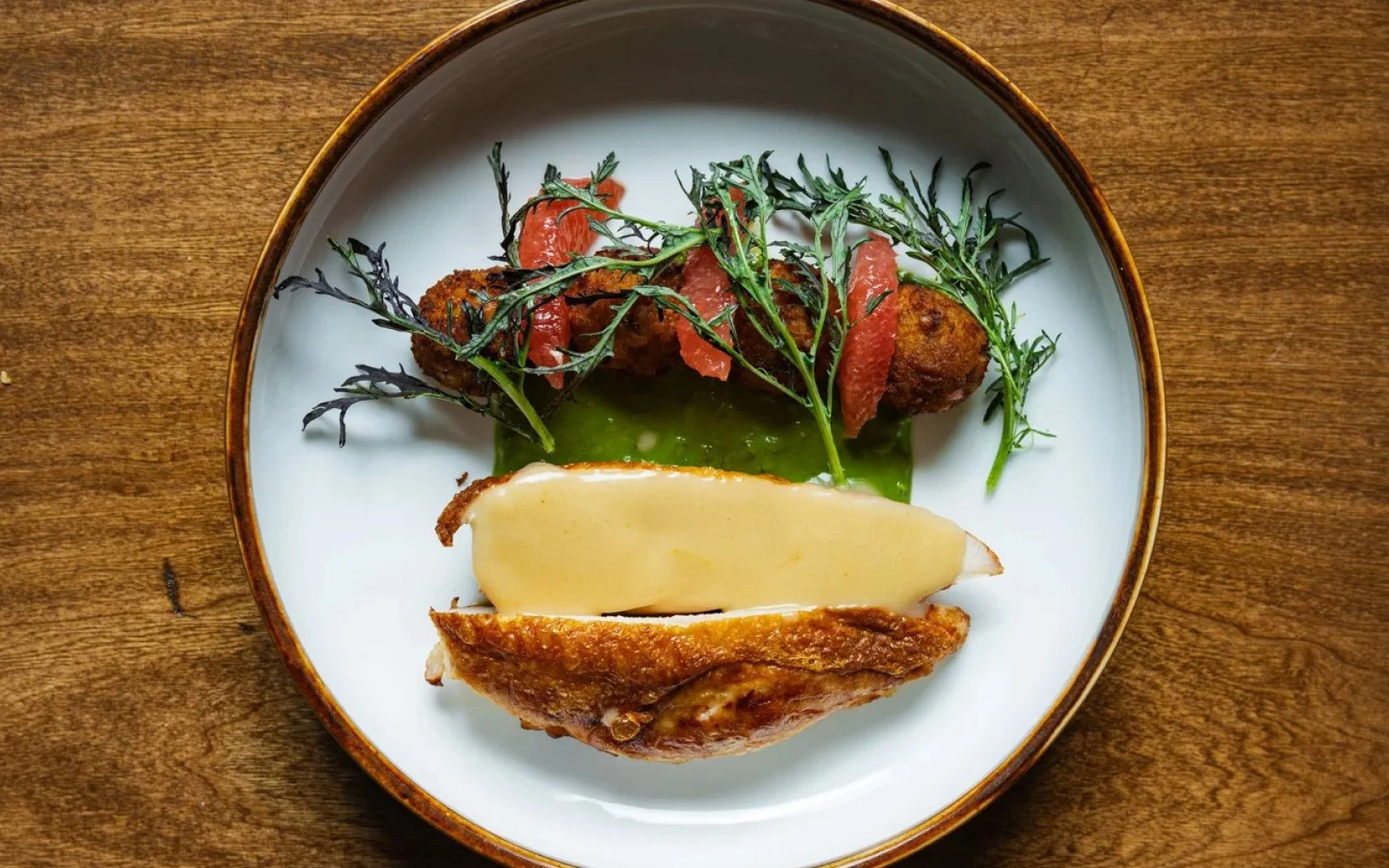  Chicken Breast, Garlic-Miso Mofongo, Buttermilk-Fermented Herb Stem Sauce, Beurre Monté, Grapefruit Supreme, Mustard Greens 