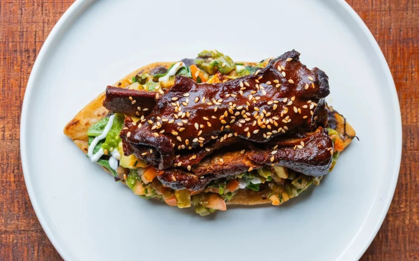  Pork Spare Rib Tlacoyo, Refried Beans, Nopales, Pico de Gallo, Salsa Verde, Sesame Seeds 