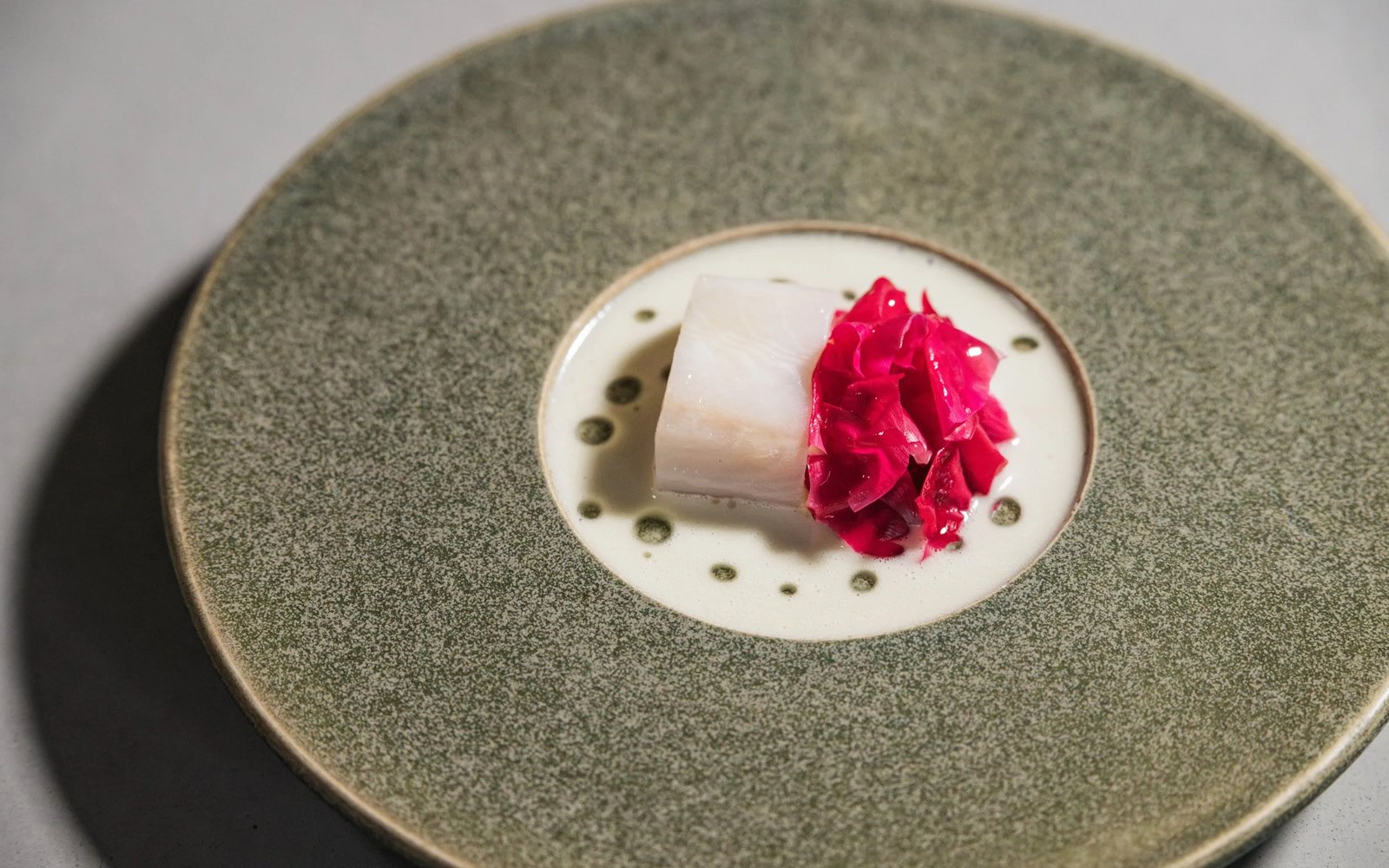  Steamed Black Cod, Grilled Sour Cherries, Unripe Strawberries, Pickled Wild Rose Pedals, Smoked Pork Fat Cream, Lacto-Fermented White Asparagus Juice, Charred White Asparagus Oil 