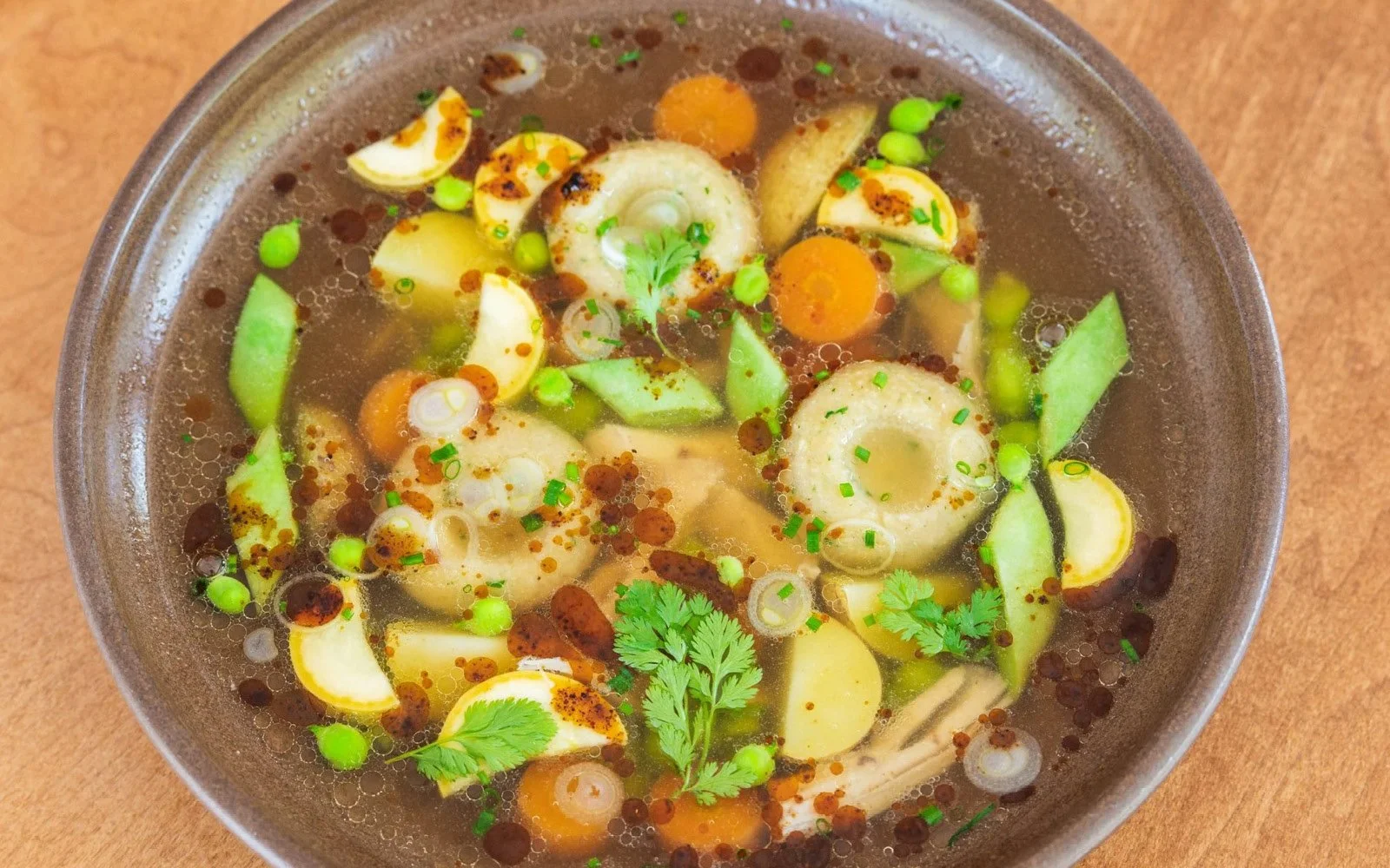  Cilantro Chochoyotes, Poached Chicken, Chicken-Ginger Broth, Summer Squash, Romano Beans, Garbanzo Beans, Peas, Salsa Negra, Scallions, Cilantro 