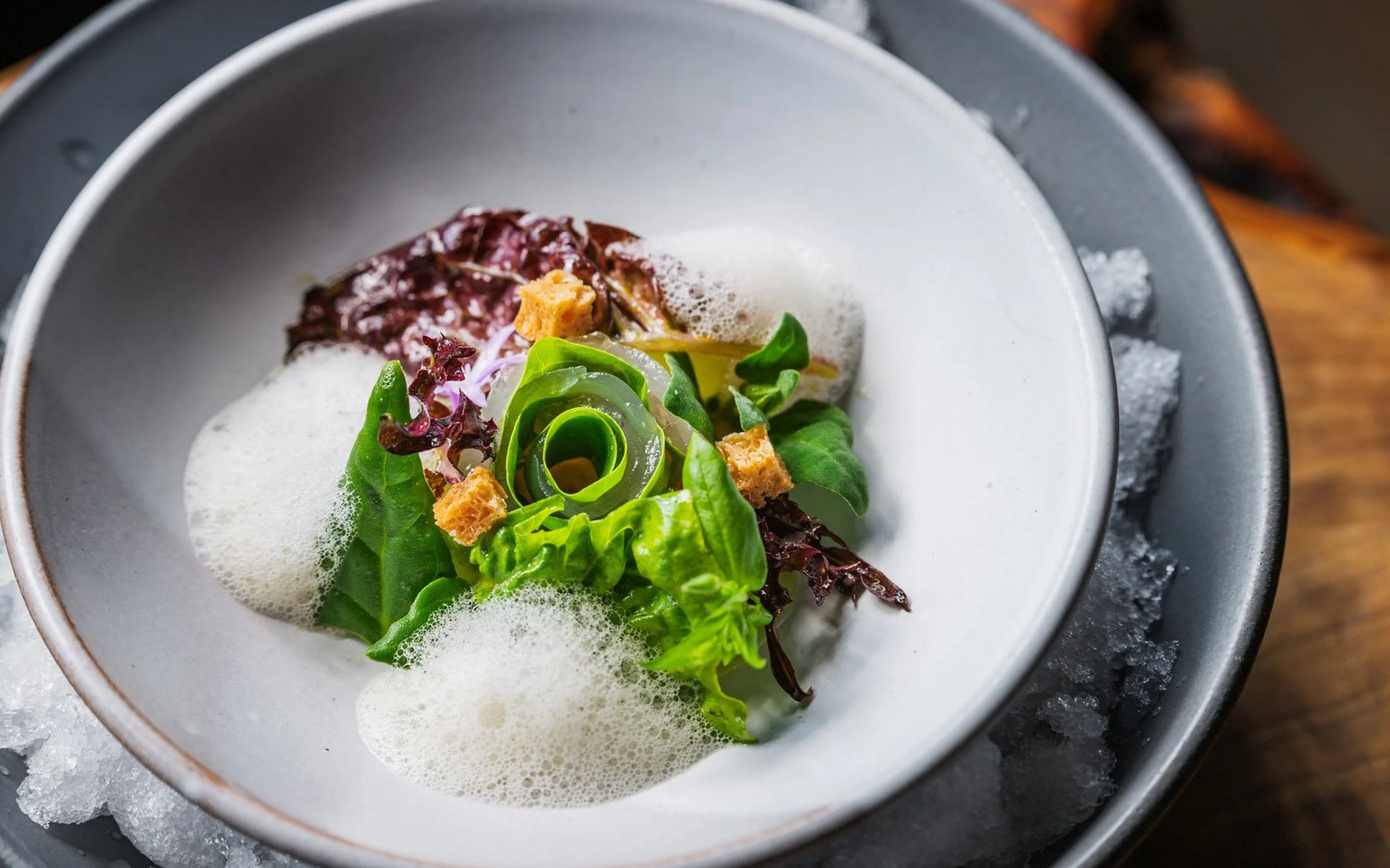  Halibut Crudo, Gem Lettuce, New Zealand Spinach, Chickweed, Green Garlic-Nasturtium Caper Dressing, Ramp Pickling Liquid, Sourdough Focaccia Croutons, Allium-Sourdough Focaccia Foam, Garlic Blossoms 