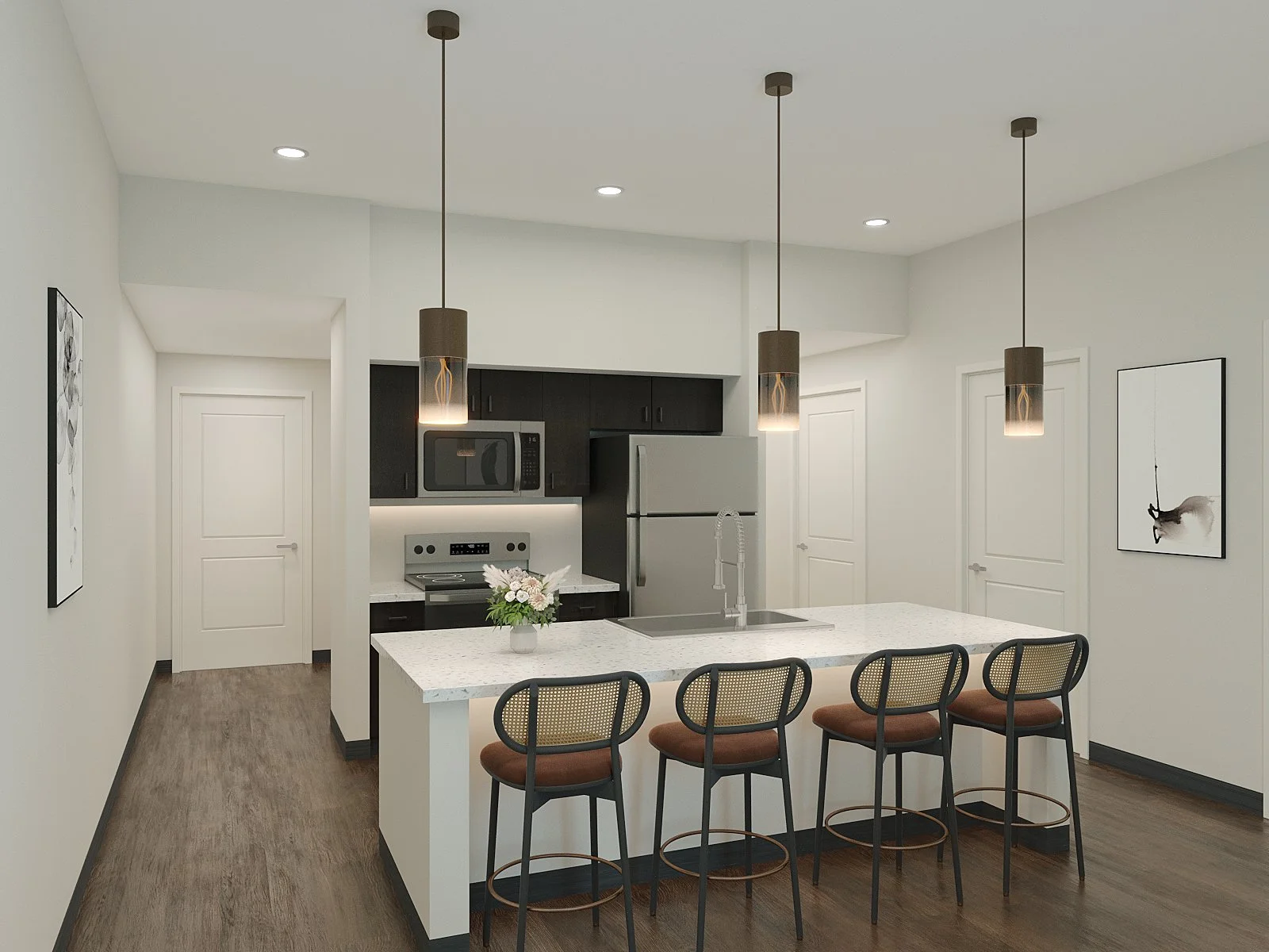 Modern kitchen with white island, black cabinets, stainless steel appliances, pendant and recessed lighting, bar stools, artwork on white walls, and wood flooring.
