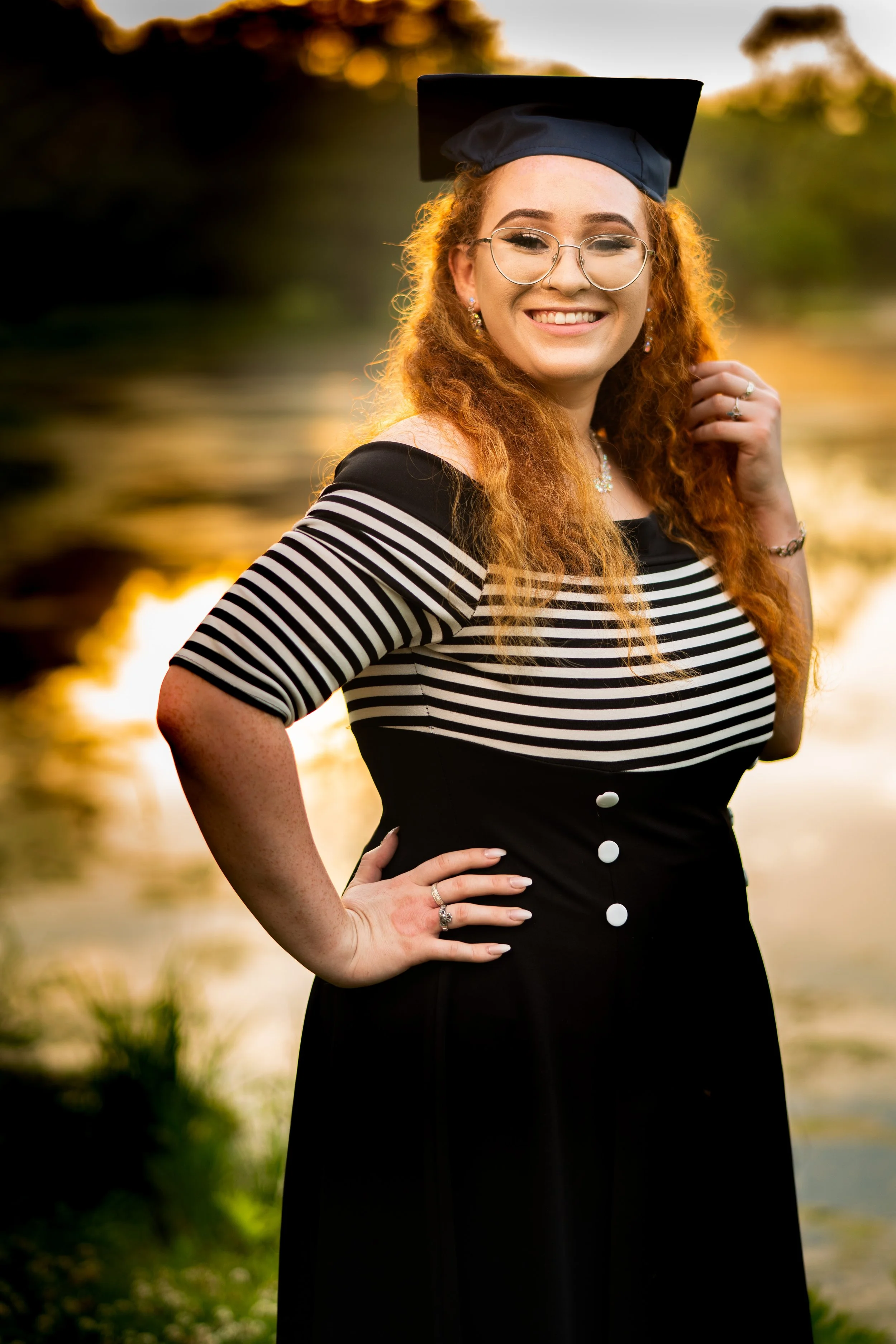 Smiling high school senior wearing her graduation cap during a sunset portrait session in Southern New Hampshire.