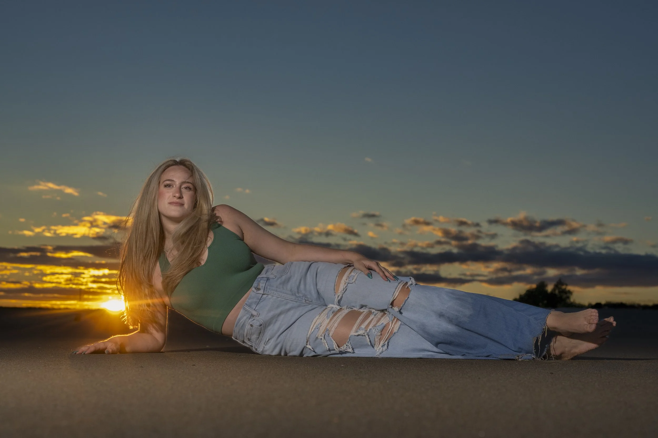 Litchfield NH high school senior reclining on the sand at sunset during her beach portrait session