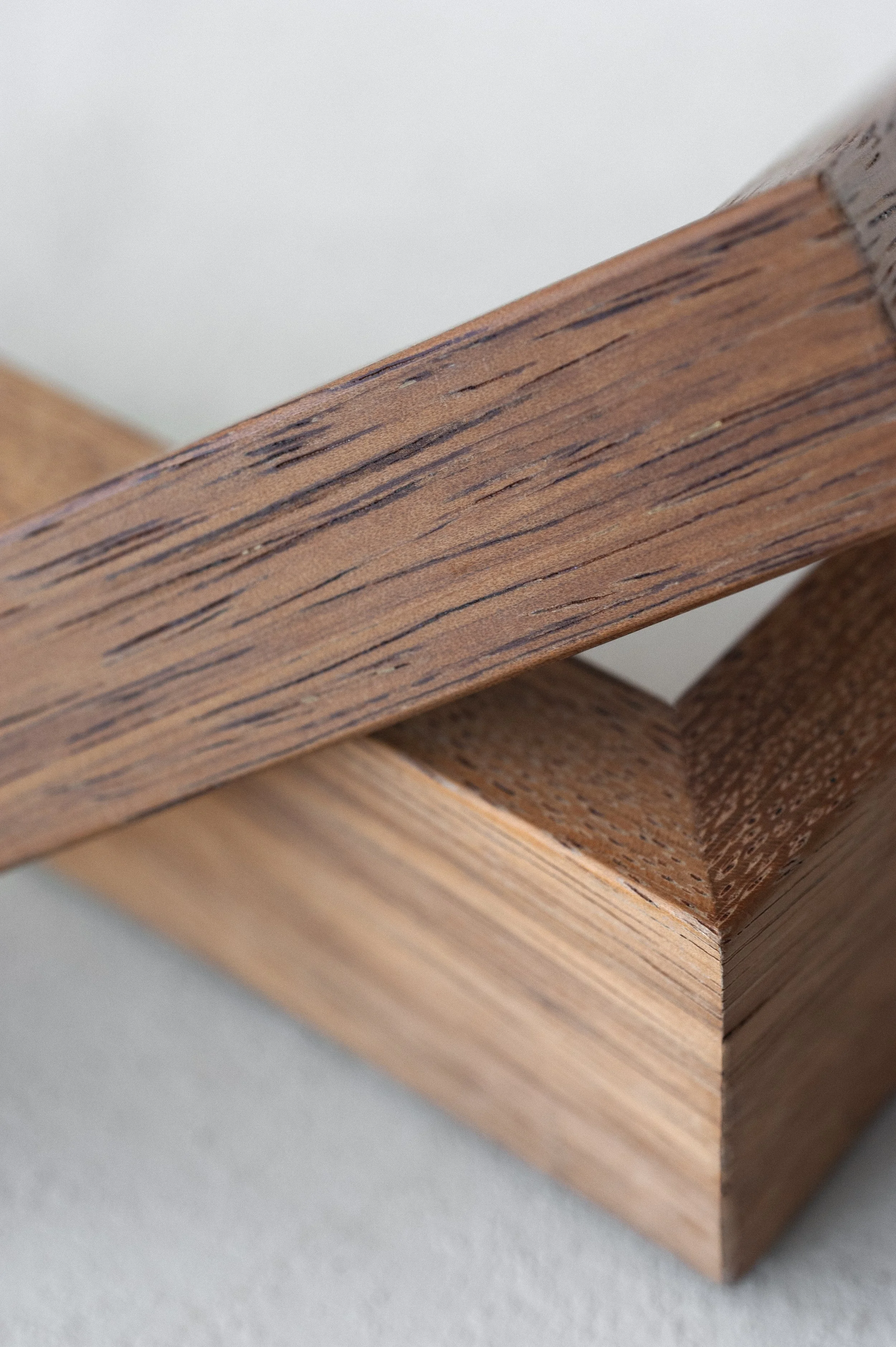 Close-up of two overlapping wooden pieces with visible grain textures.