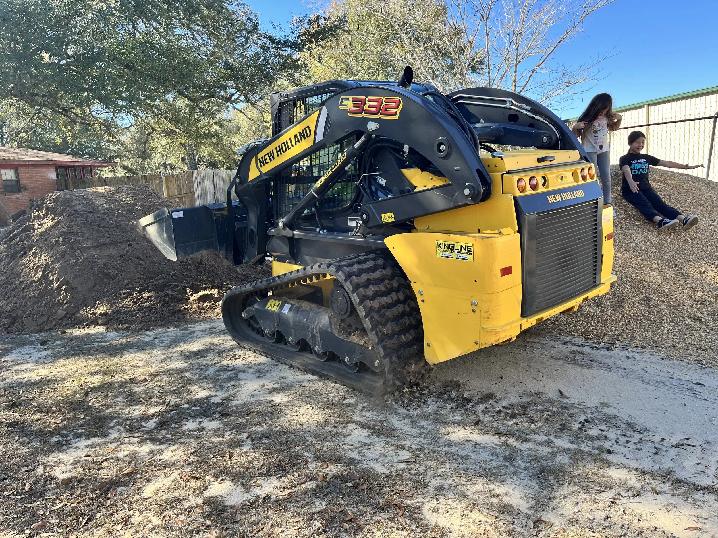 Skid steer performing dirt work and site preparation in Crestview FL