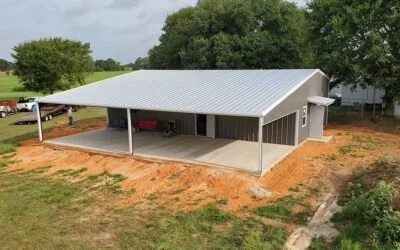 A newly constructed metal building with a silver roof, open sides, and a concrete floor.  Site Work, Foundation, Steel Frame and Sheet Metal.