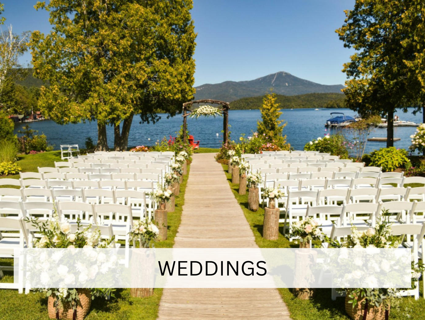 wedding arch draped with flowing white fabric and adorned with fresh flowers, standing in a serene outdoor setting. This decorative piece adds an elegant touch to ceremonies and special occasions.