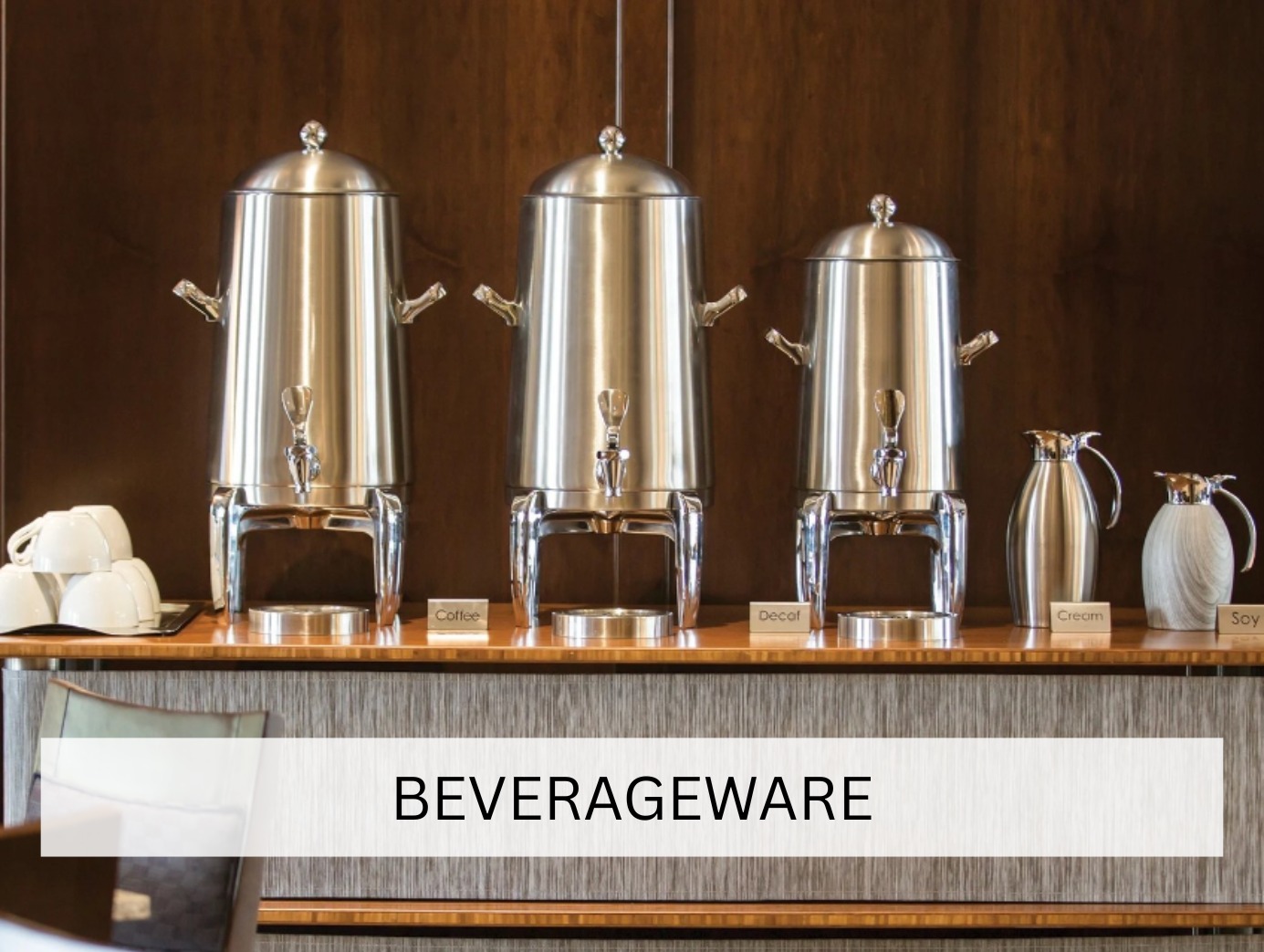 A sleek silver pitcher, likely used for serving beverages at events, displayed against a neutral backdrop. The polished finish adds a touch of class to the beverage service.