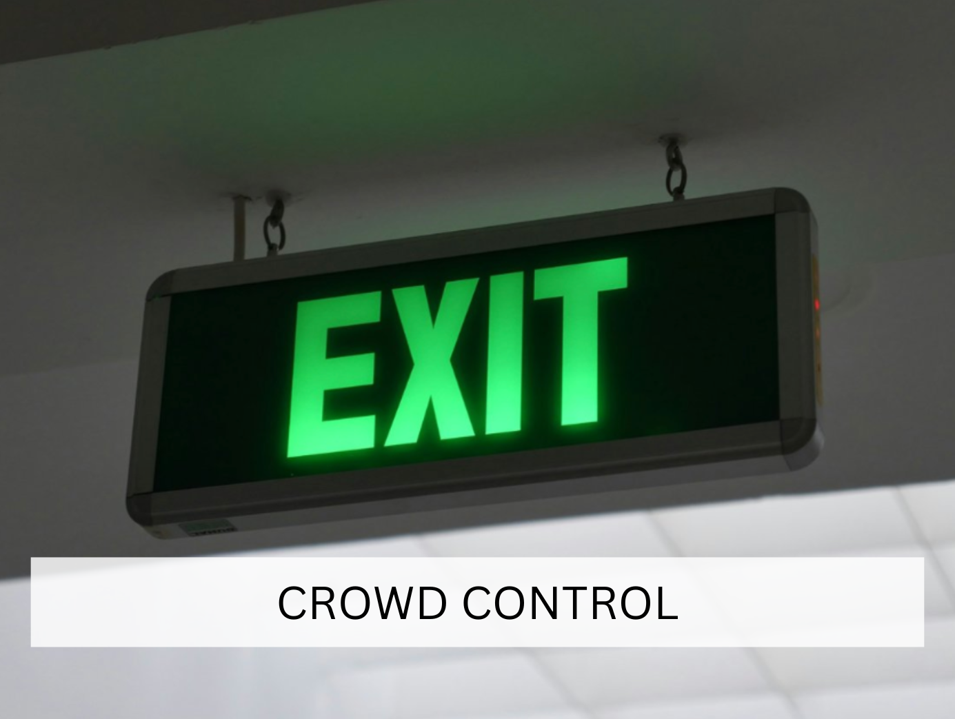 A glowing green exit sign, clearly marking the way out for safety during indoor events. This essential piece of equipment ensures safety compliance in crowded venue