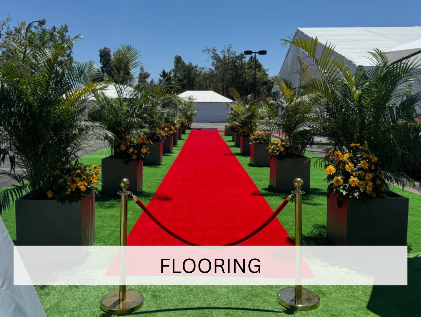 A close-up of fresh green turf laid out on a wooden platform, highlighting its lush and vibrant appearance. The texture suggests it's designed for event decoration or landscaping.