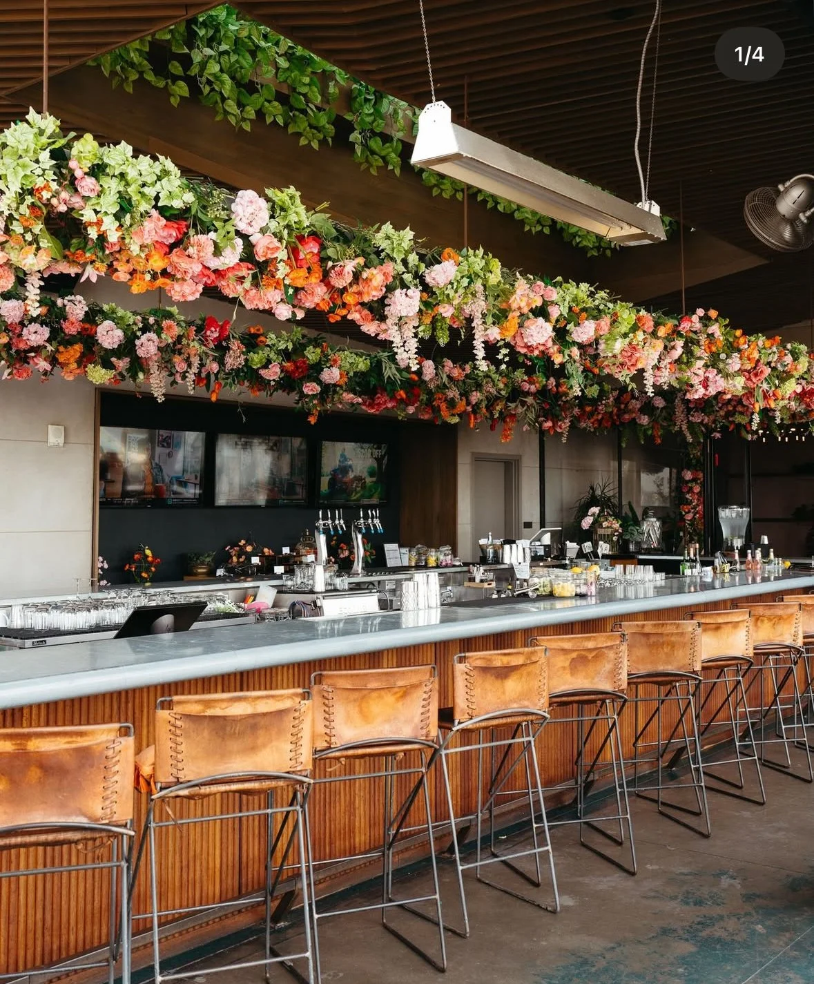 Rooftop floral installation at Noelle Nashville bar with overhead greenery and immersive event design