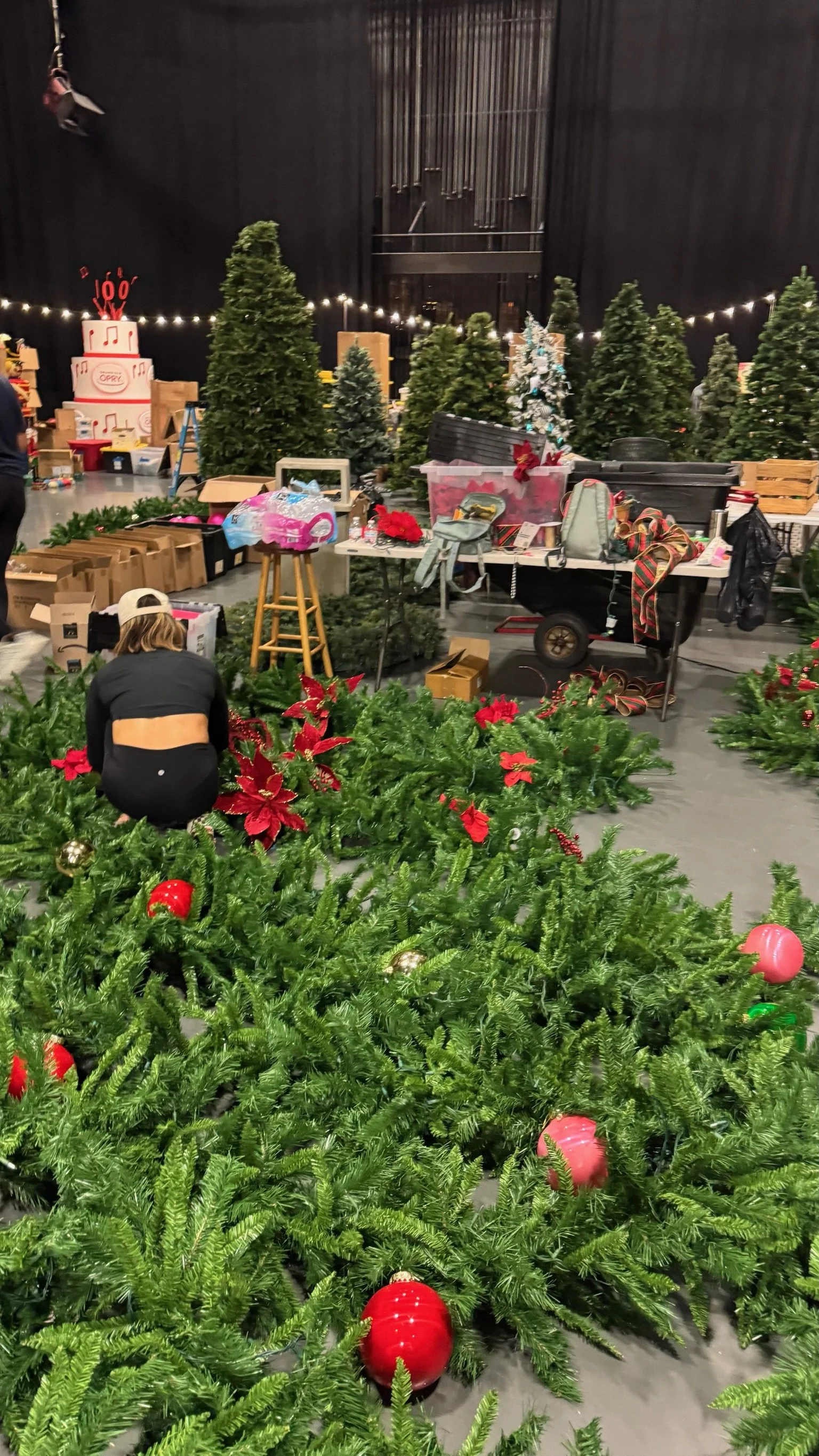 Behind the scenes holiday set decorating prep with Christmas trees, greenery, and decor inventory for film and television productions in Nashville.