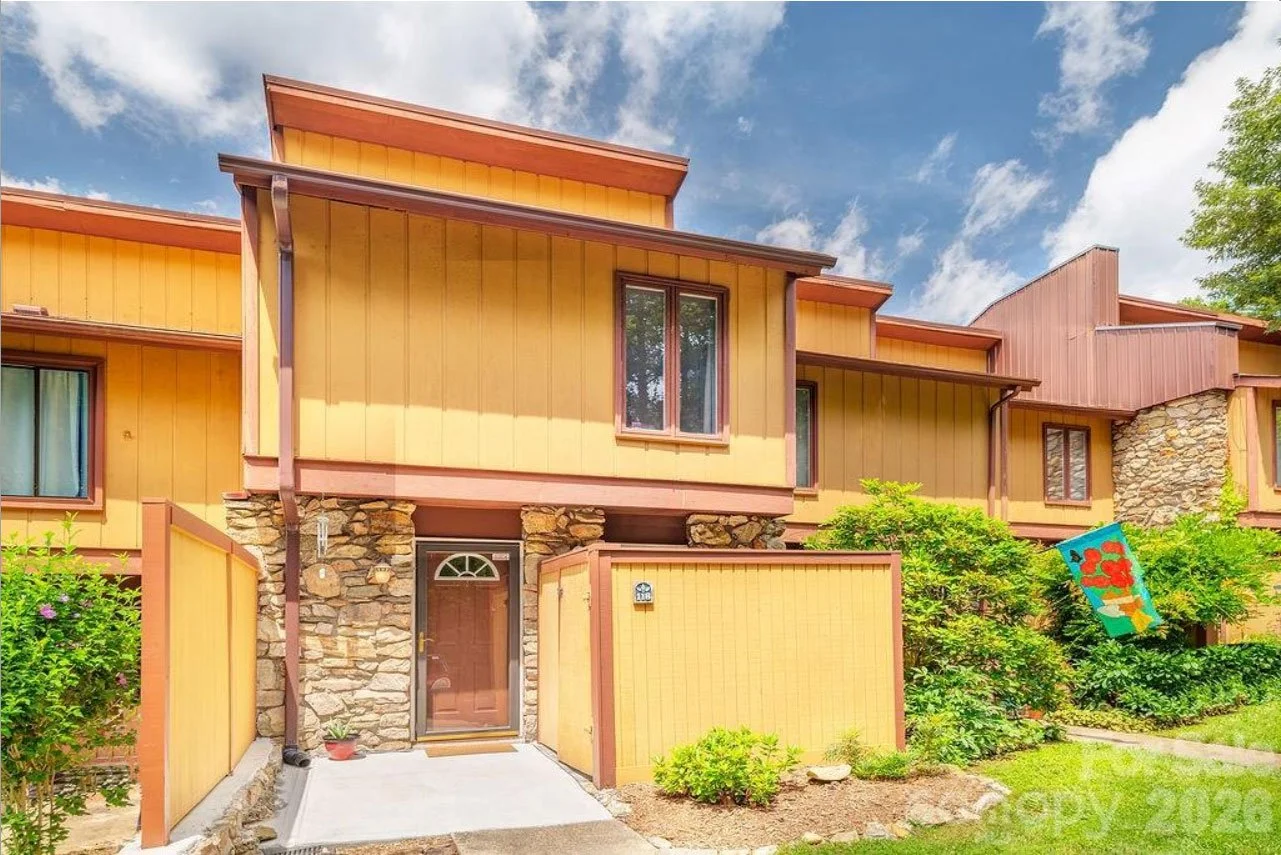 Townhome in Arden NC sold showing two levels wood and stone siding with green landscaping