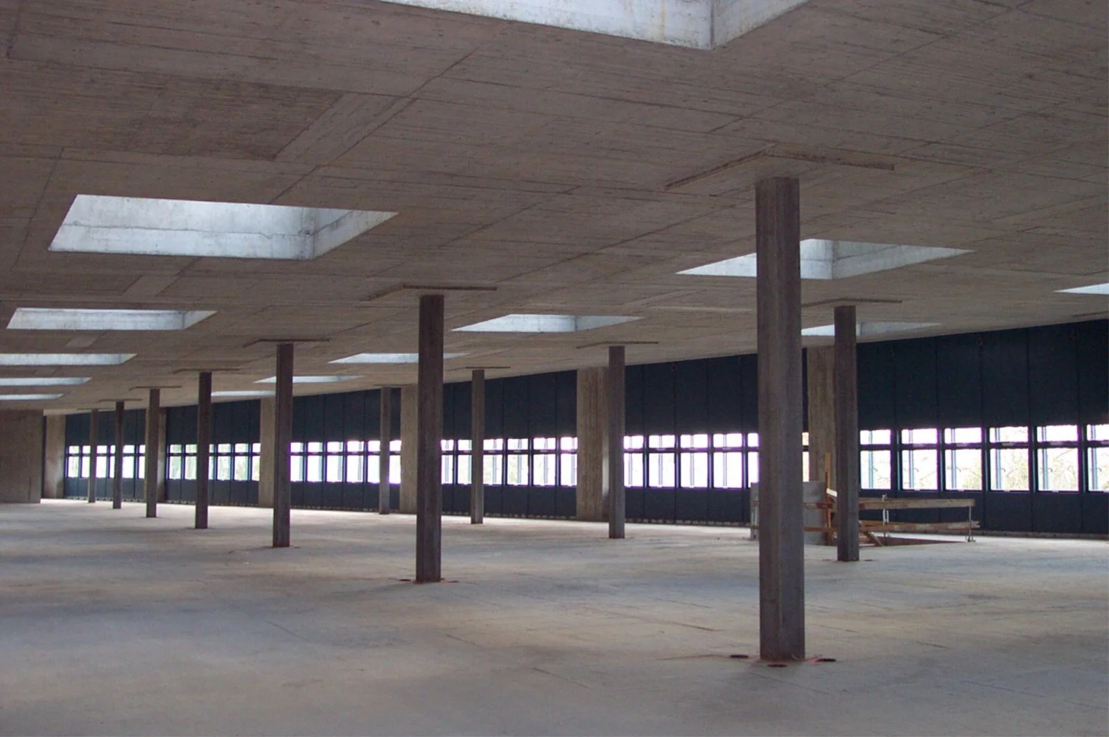  Image of the top floor of the Primary System showing four drainage pipe sleeves at each column. Skylights are indicative of the ‘punch-out’ panels on all floors in the center of each structural bay for future light wells and other vertical services.