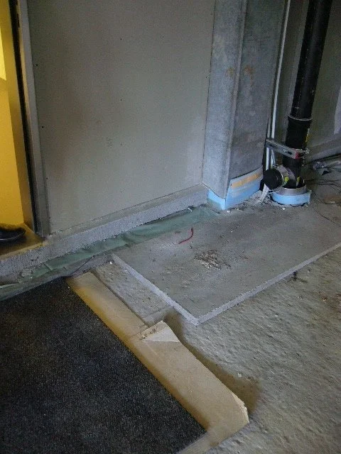  Image of the Primary system concrete slab and column, a pipe sleeve used for drainage piping, and membrane separating the primary system slab from the secondary lightweight concrete slab. (Photo credit: Stephen Kendall) 