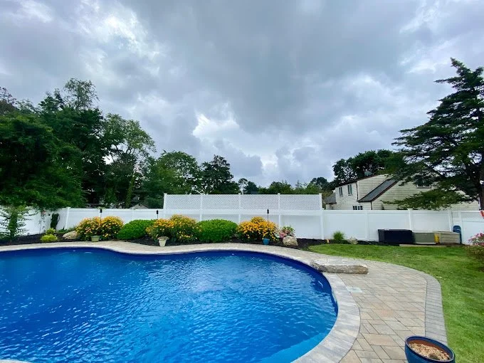 white vinyl privacy fence with lattice top.jpeg